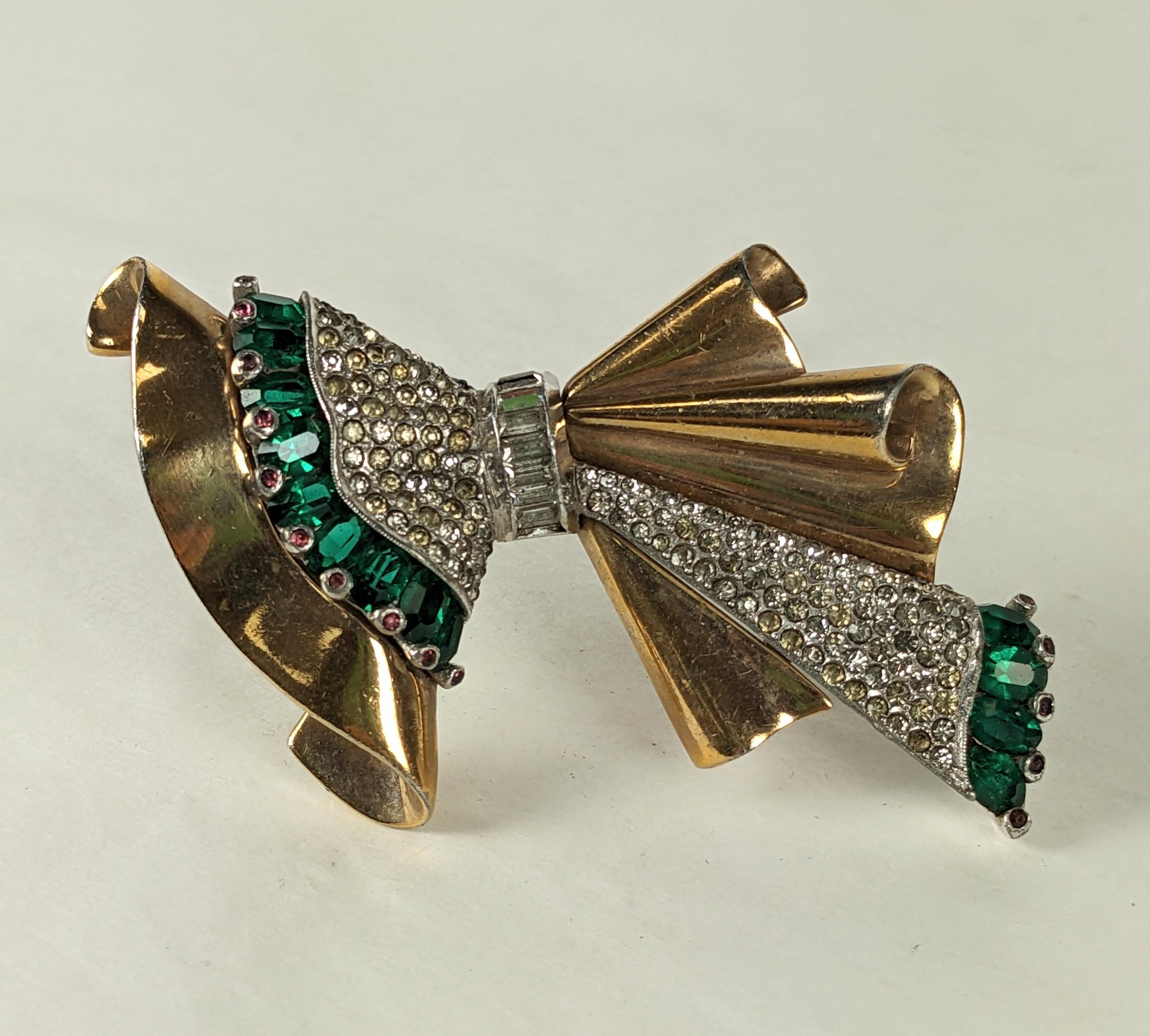 Amazing Pennino Retro Gathered Bow Brooch from the 1940's. Pink gold retro fan is paired with a rhodium and pave element edged in oval cut faux emeralds and tiny ruby cabs. 3.25