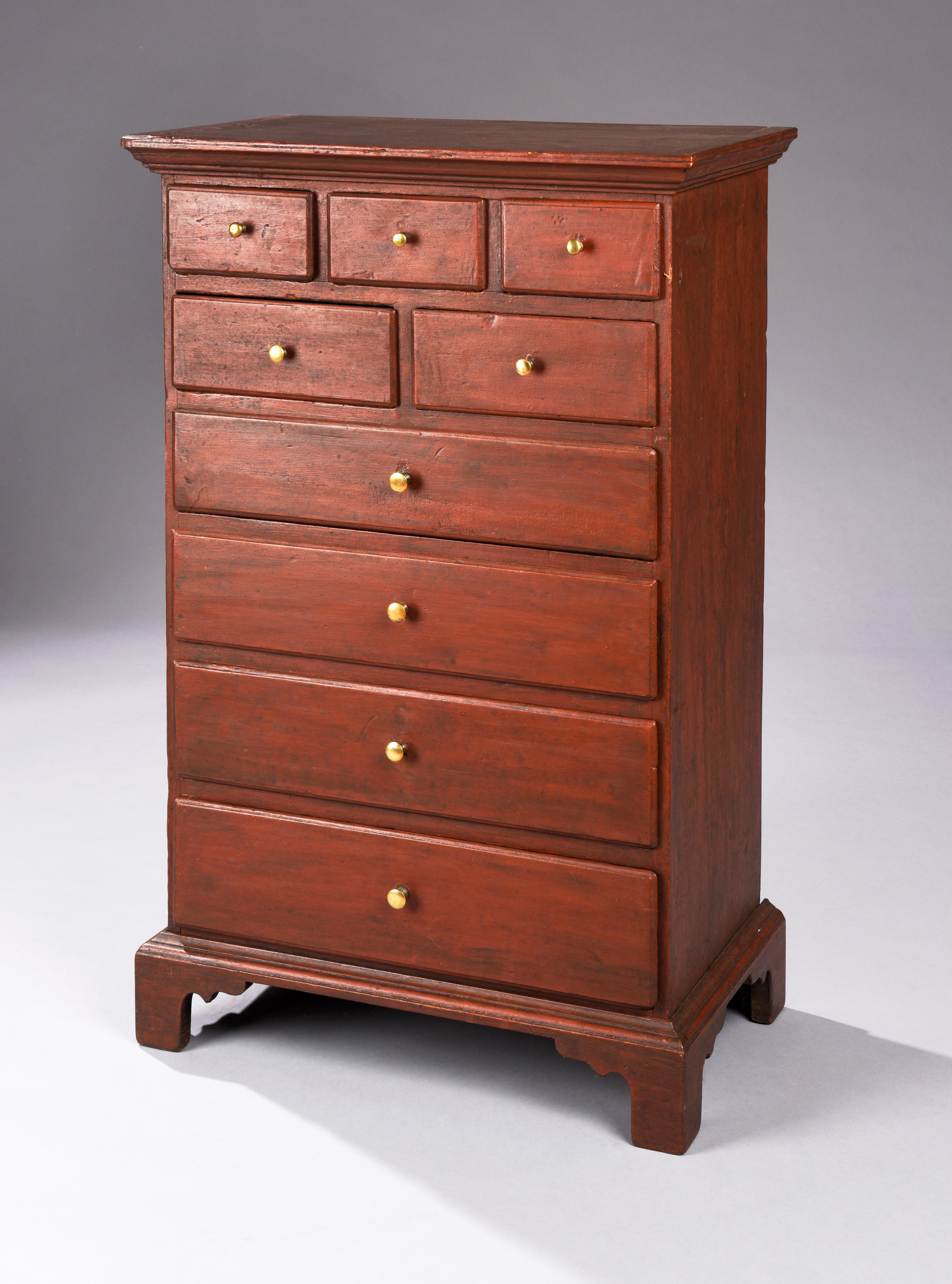 Delightful child's sized Pennsylvania high chest in red paint. Three over two over four drawer arrangement and resting on bracket feet, circa 1800. Tulip poplar.