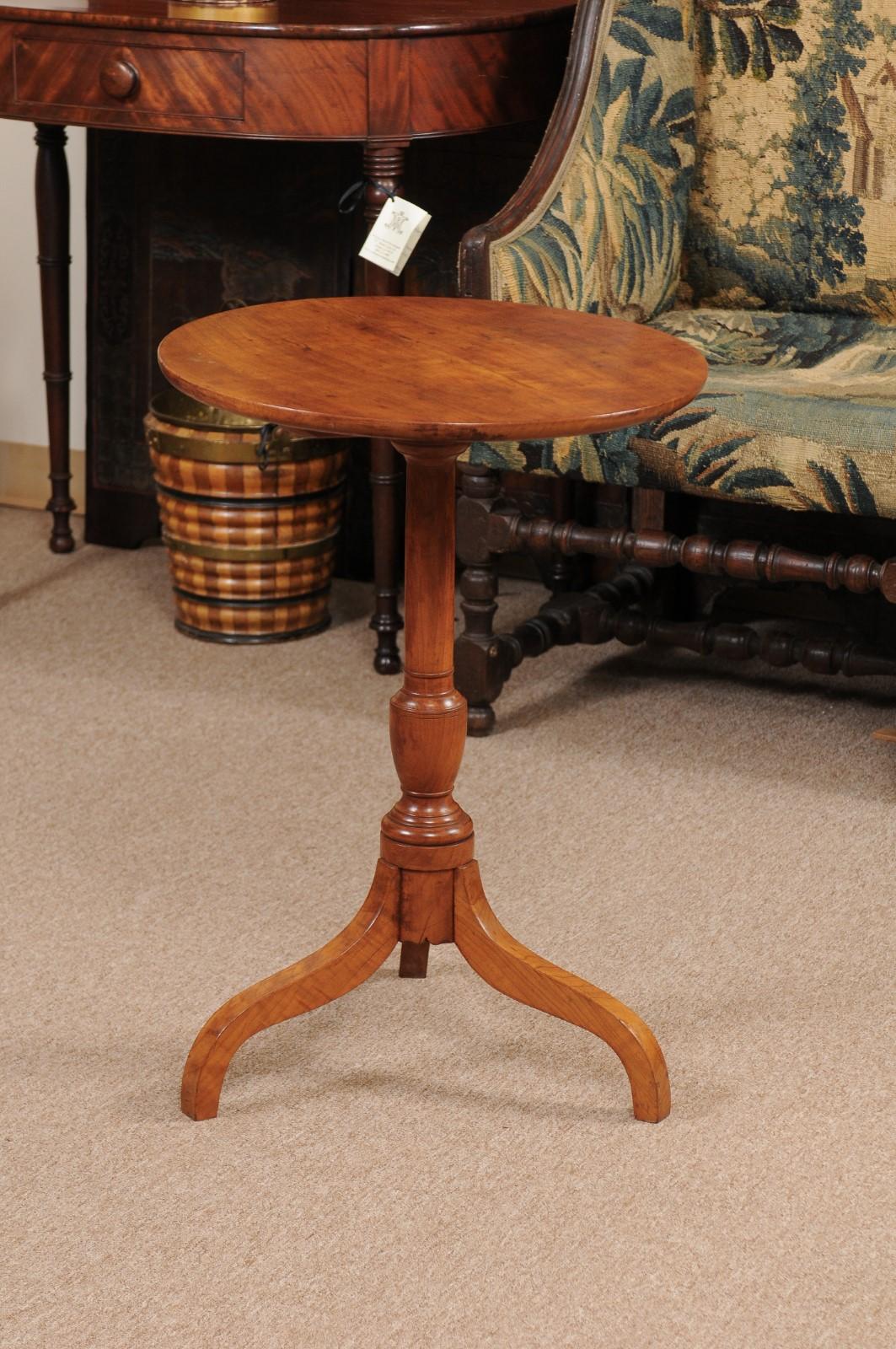 The candle stand with circular top with tilting mechanism and tripod base.