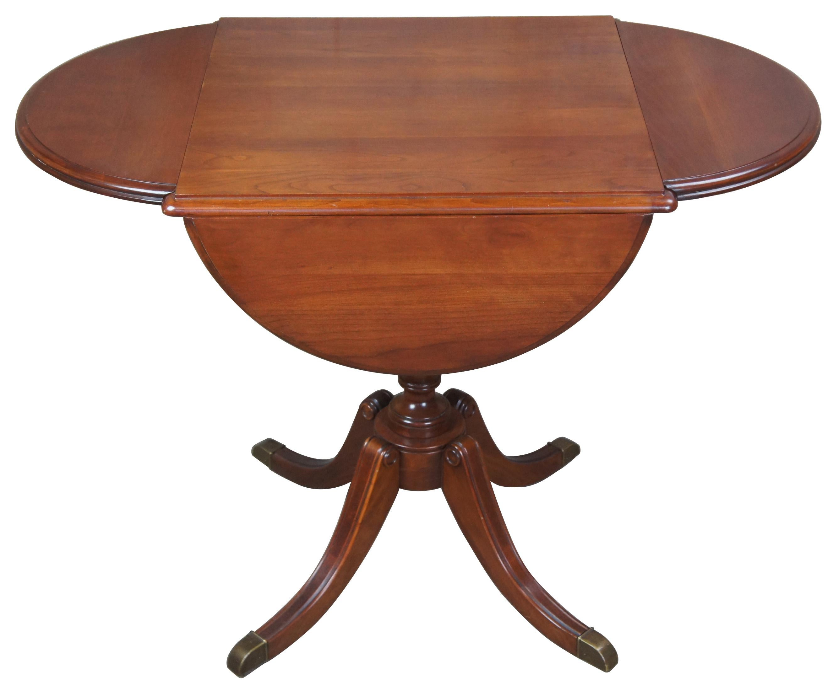 Pennsylvania House cherry Duncan Phyfe four sided drop-leaf side accent table

Pennsylvania House clover leaf accent table. Features Duncan Phyfe styling with curved legs leading to brass caps and four independent drop-leafs, circa 1960s.
  