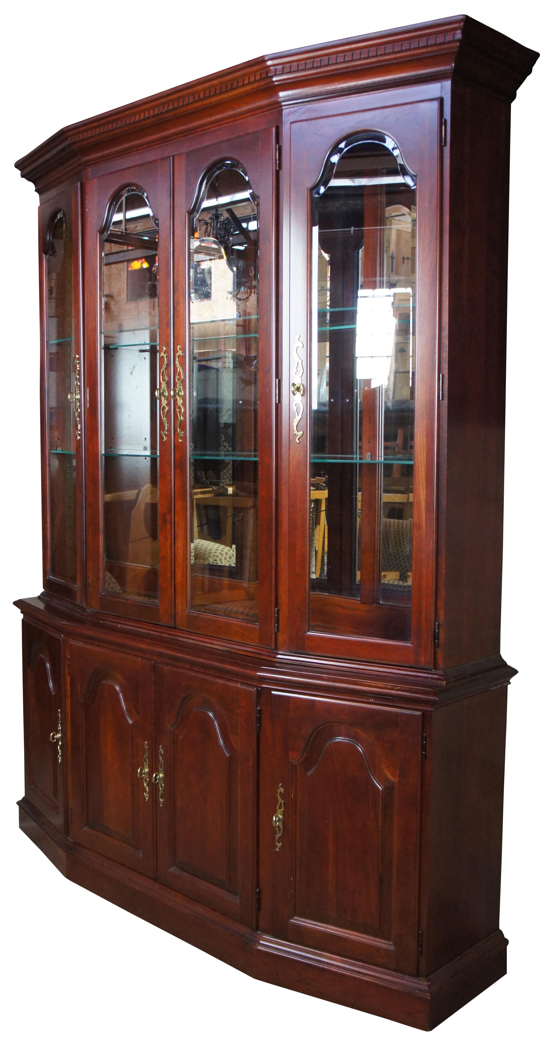 Pennsylvania House solid cherry two-piece break front illuminated china cabinet. Features adjustable shelves and two dovetailed drawers with a silverware cloth. Includes plate grooves along the back for display. #50-3611.
 