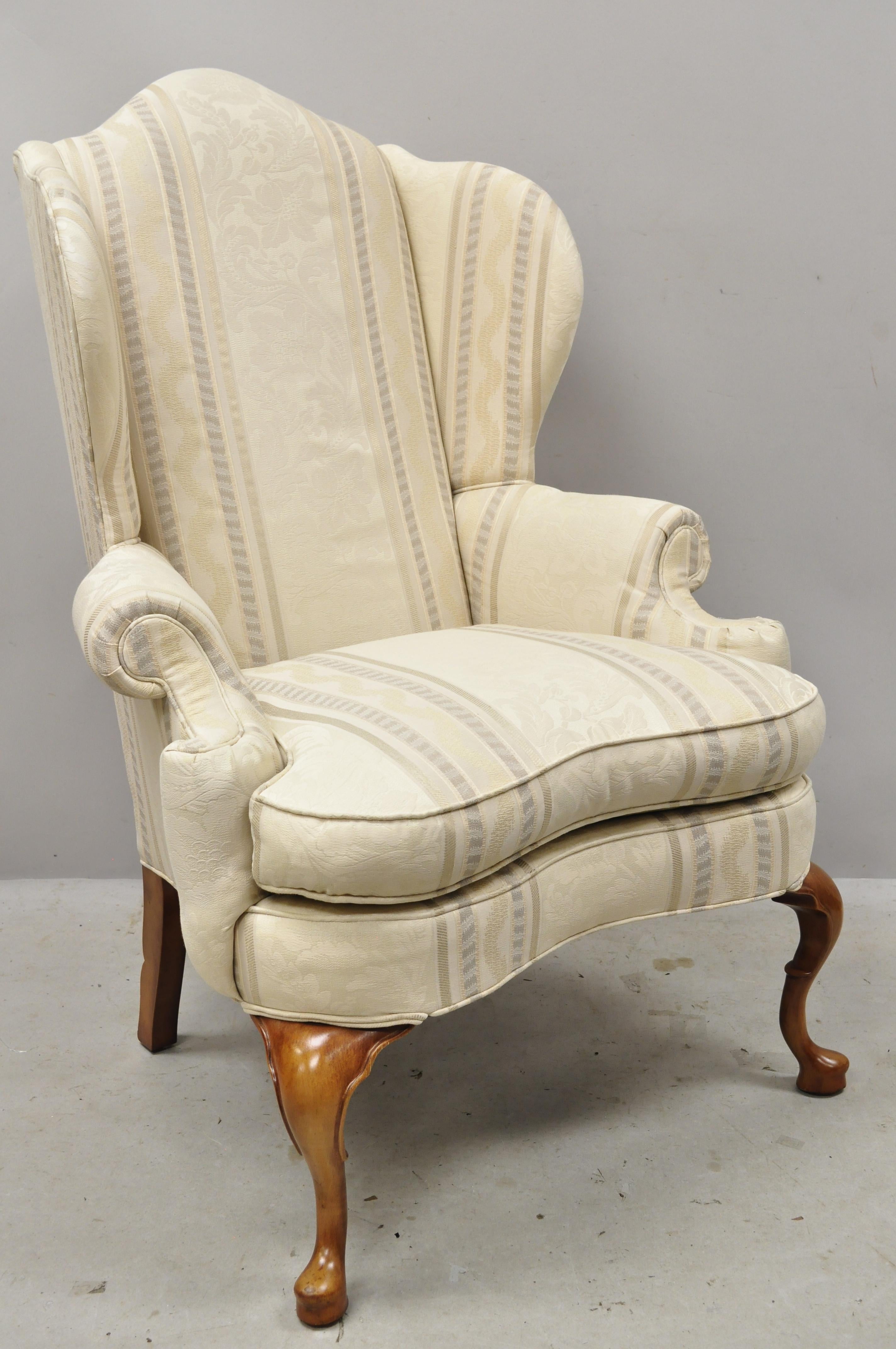 Pennsylvania house Queen Anne rolled arm wingback lounge armchair. Item features rolled arms, tall winged back, notch carved rear legs, bow front, solid wood frame, beautiful wood grain, original labels, shapely Queen Anne legs, quality American