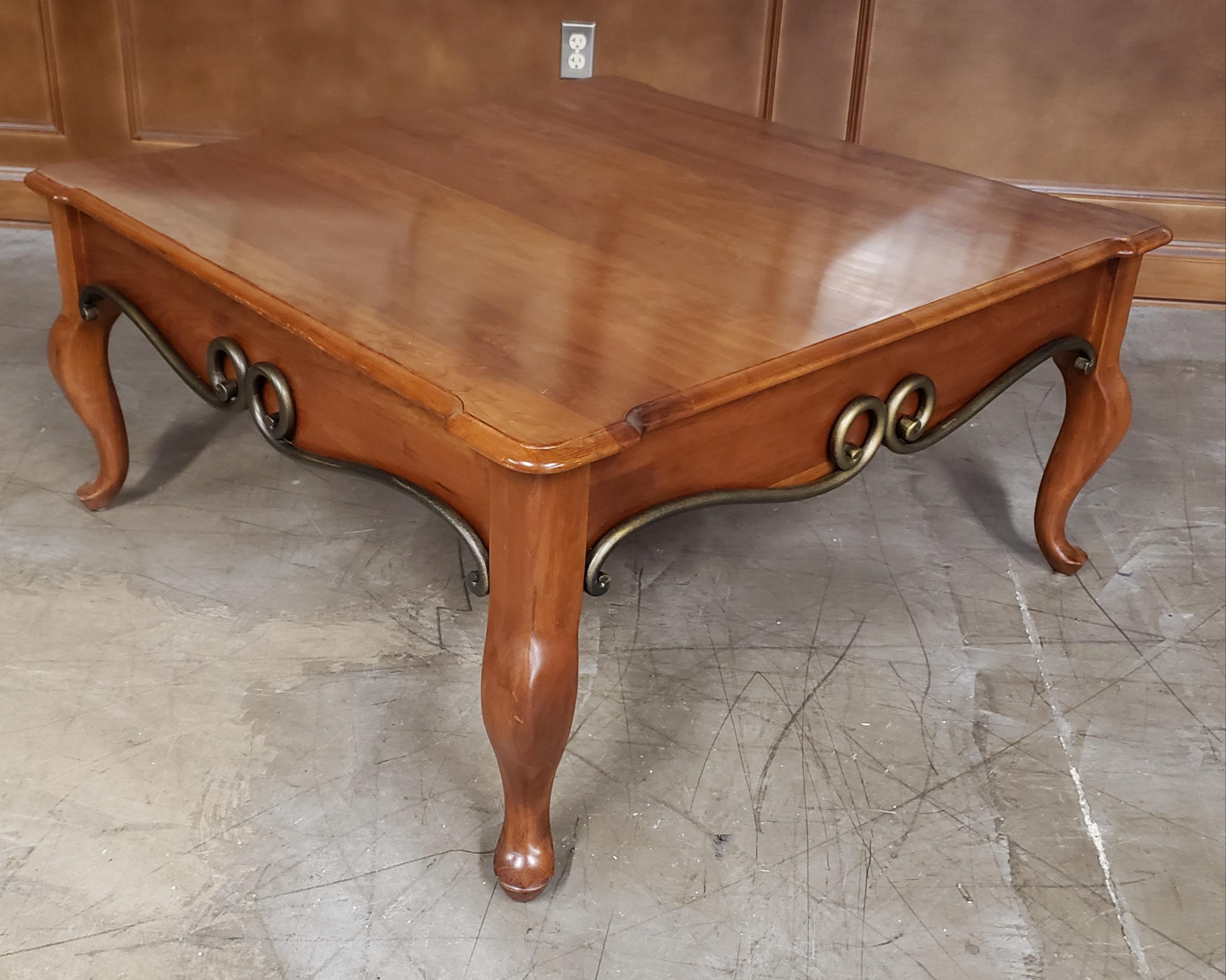 A Pennsylvania House solid cherry and patinated metal coffee table with Queen Anne feet.
Measures 42