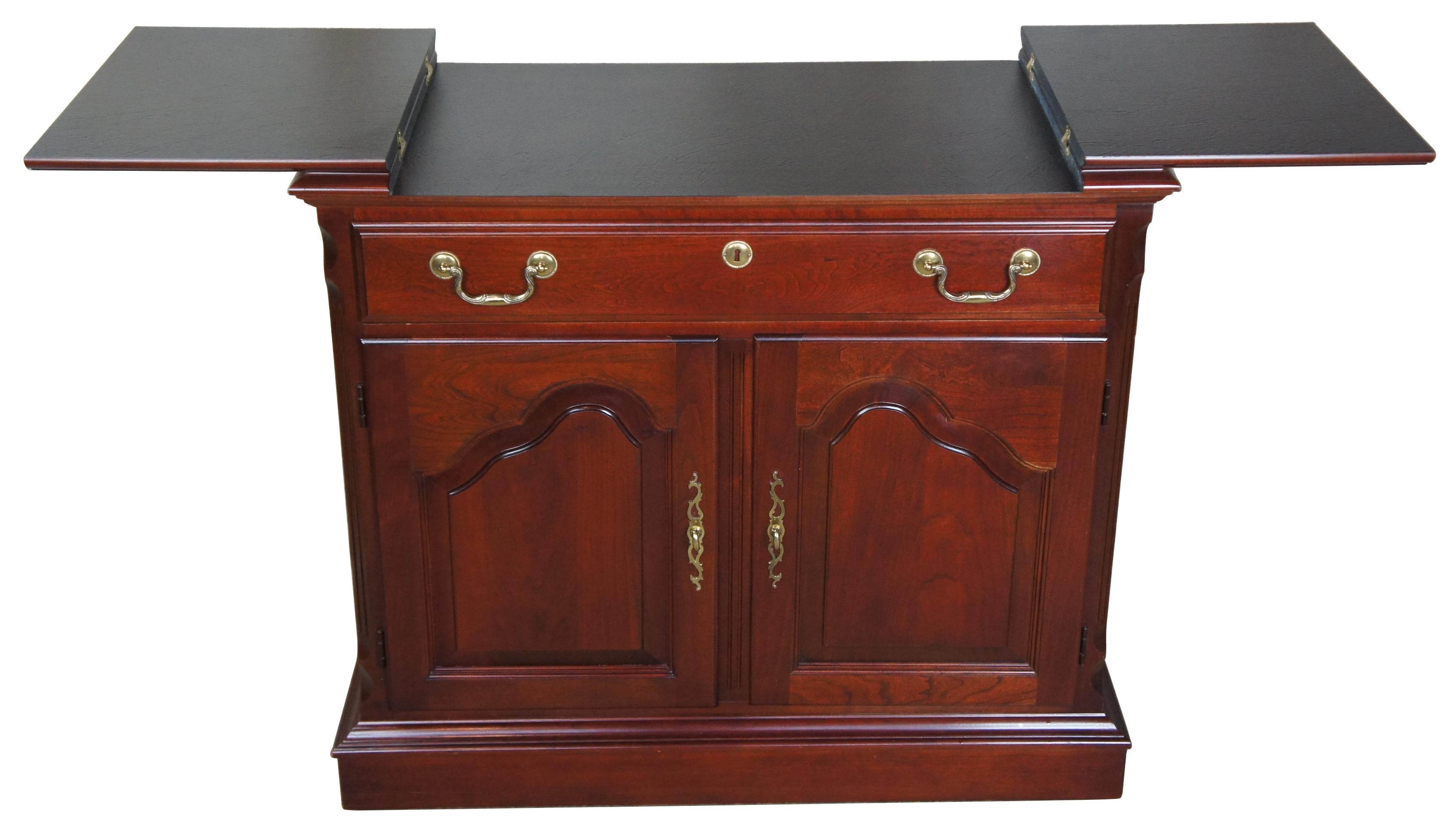 Vintage Pennsylvania House flip top cherry buffet, server or cabinet. Made of solid cherry construction with traditional styling, raised panel cabinet doors with dovetailed drawers, brass hardware, and drawer. The top opens to a formica surface,