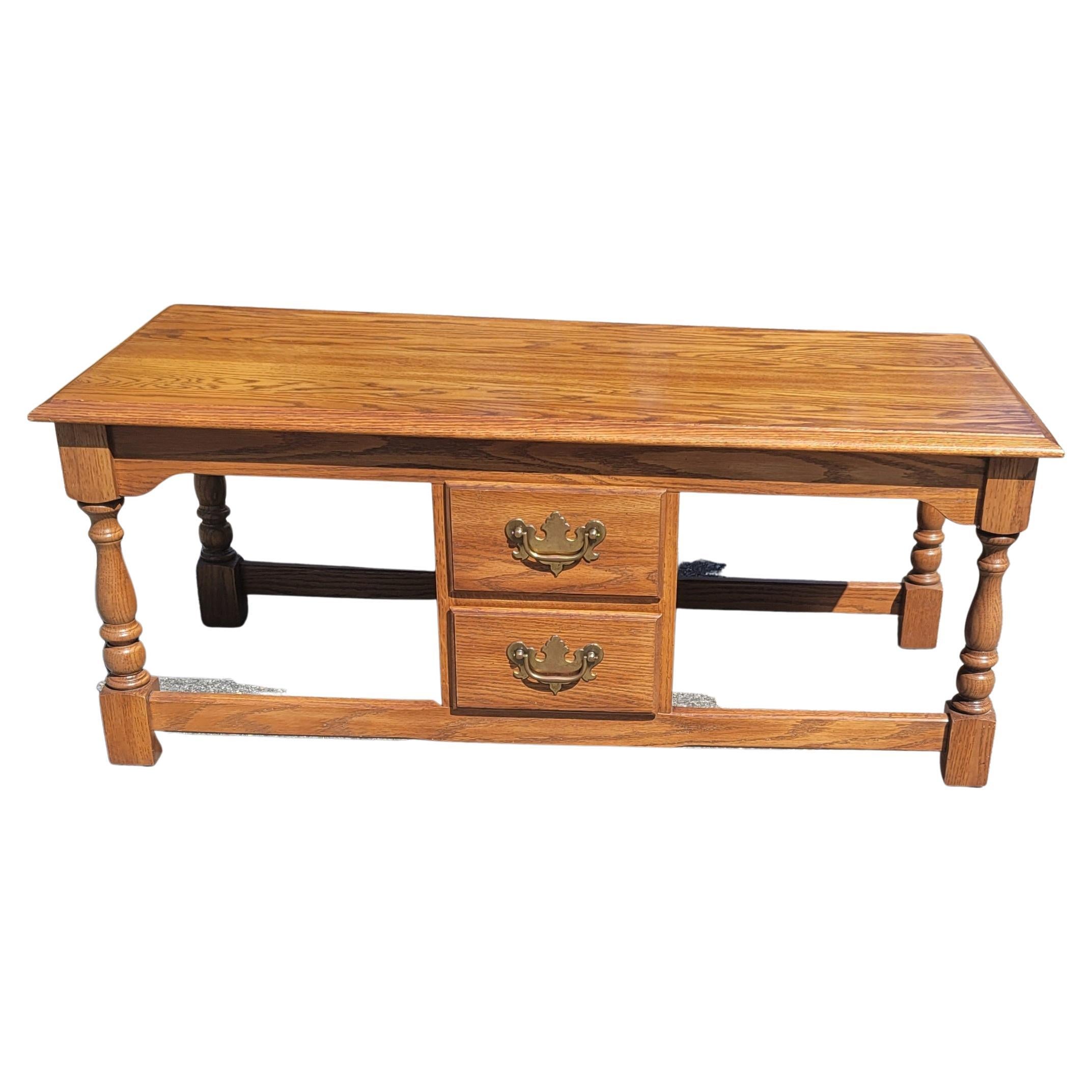 Pennsylvania House two-drawer solid oak petite coffee table or cocktail table in great condition. Feature two actual drawers on one side and two faux drawers on the other side. Measures 39.75