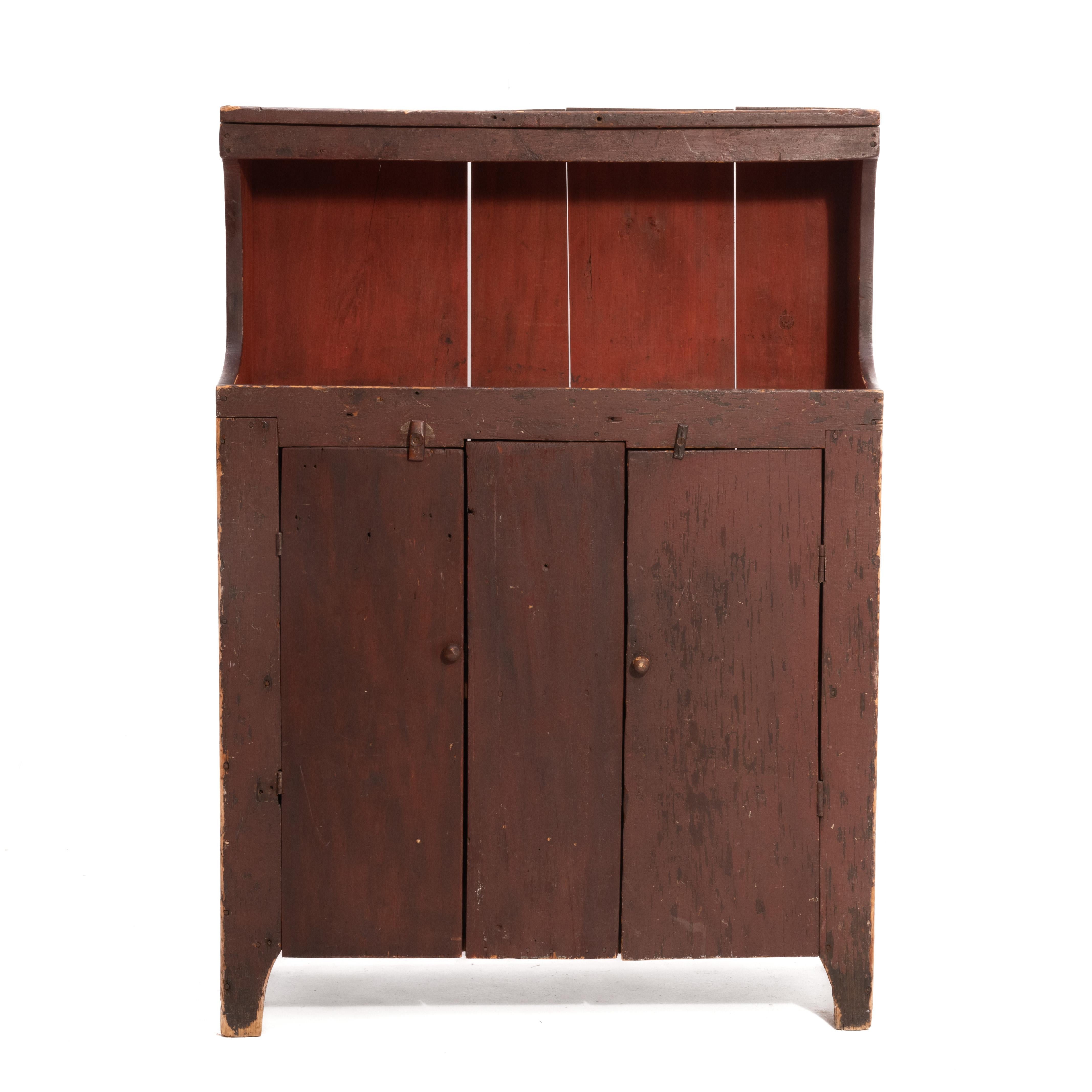 A late 19th century Pennsylvania dry sink or cupboard resting on high cut out feet. Clean interior with sturdy shelves for storage. The opening is about 14.6
