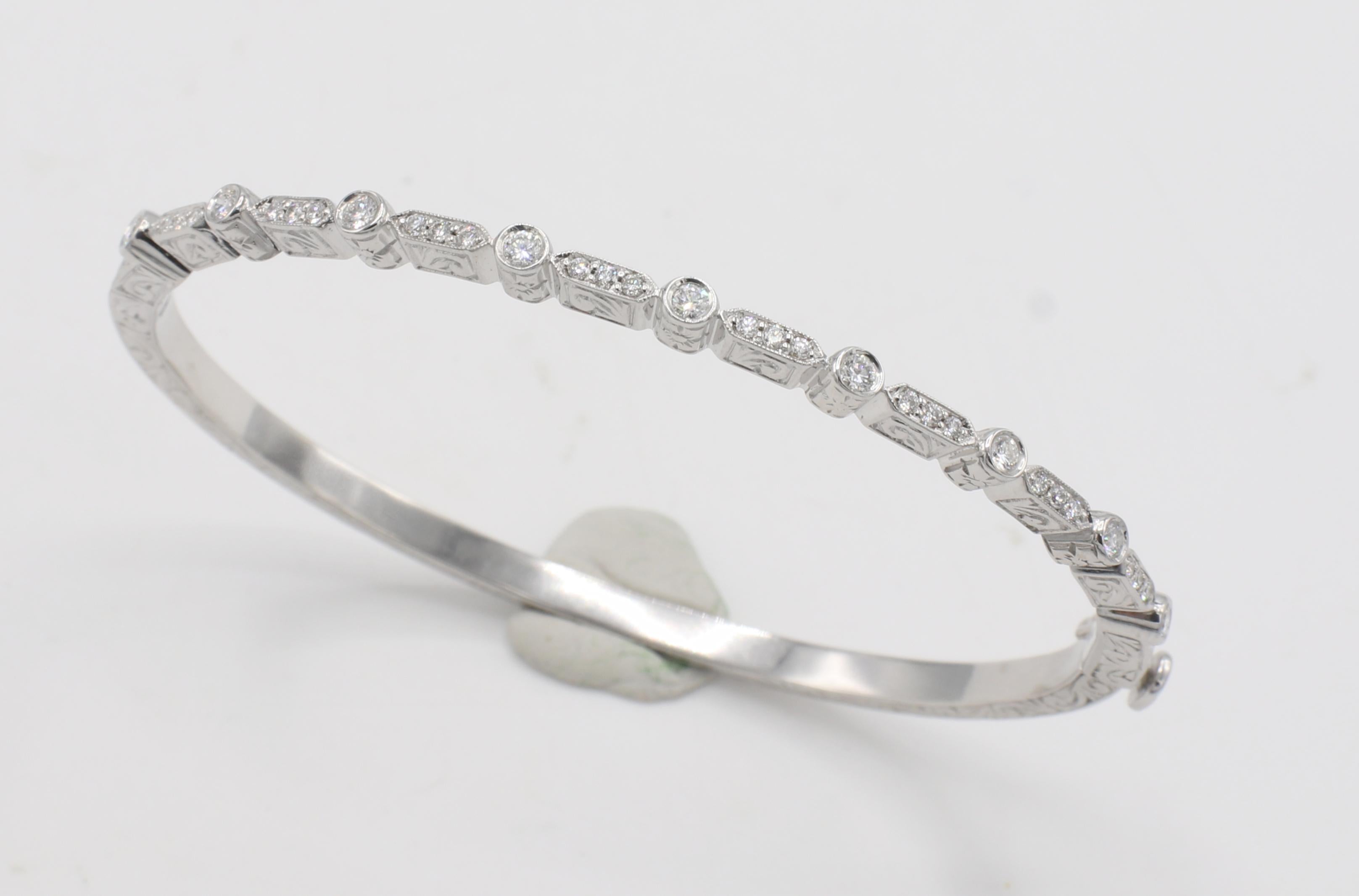 Penny Preville 18 Karat White Gold & Natural Diamond Hinged Bangle Bracelet 
Metal: 18k white gold
Weight: 16.35 grams
Diamonds: Approx. .40 CTW G VS round natural diamonds
Diameter: 56mm
Length: Fits a wrist size approx. 6.5