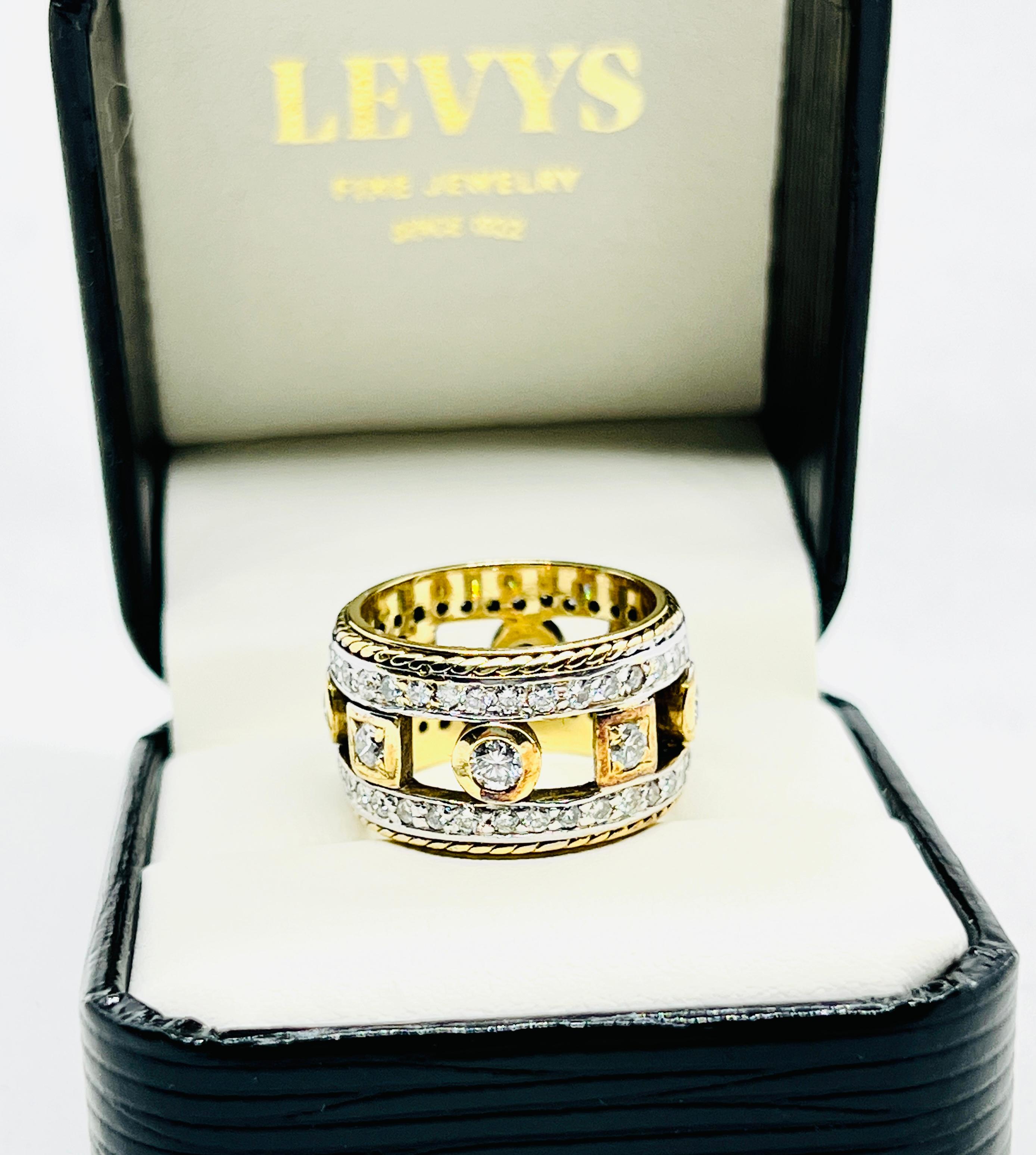 Gorgeous Penny Preville Estate Band. Penny Preville band in 18k yellow gold with 4 bezel-set and 70 prong-set round brilliant diamonds weighing approximately 1.5cttw. The diamonds are of F-G color and VS clarity. Size is 6.25 and it weighs 13.5