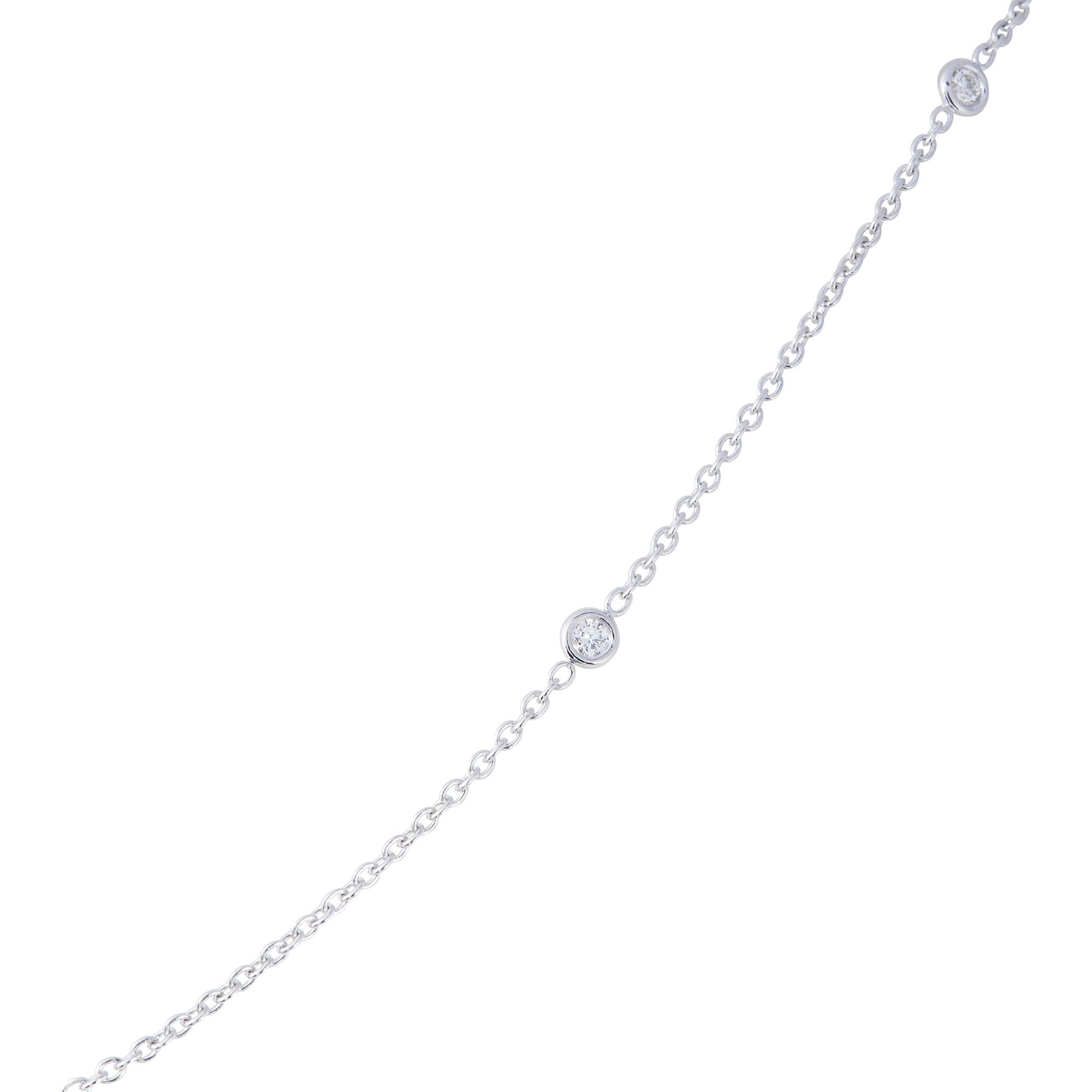 Authentic Penny Preville necklace crafted in 18 karat white gold.  The delicate adjustable chain necklace measures 18 inches in length and is accented by 6 stations featuring bezel set round brilliant cut diamonds of approximately 0.25 carats total