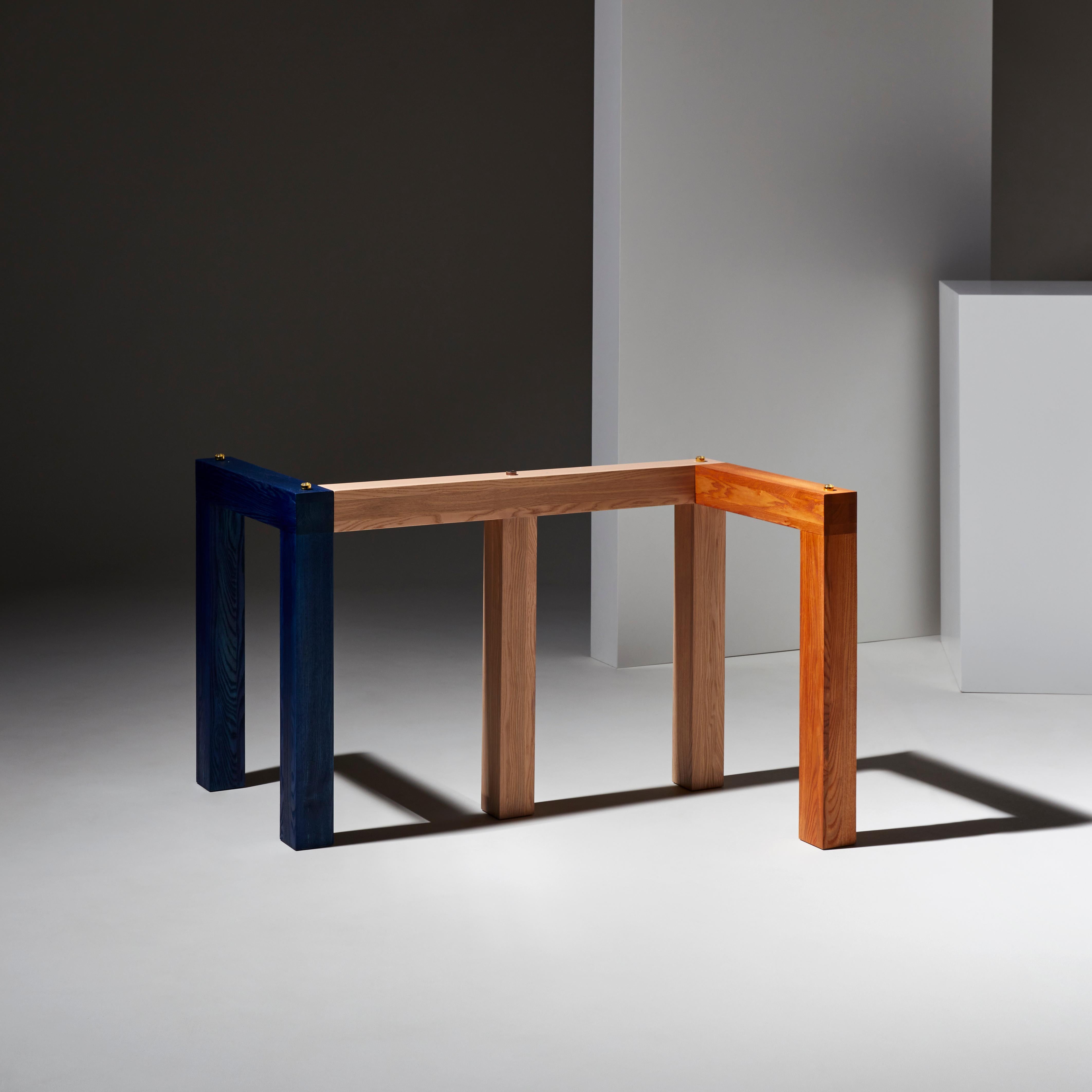 Penrose is a large dinner table in wood and glass. The design was inspired by the geometric research of mathematician Roger Penrose and his famous impossible triangle.
Depending on the point of view, the legs overlap or blend to form shapes with 3,