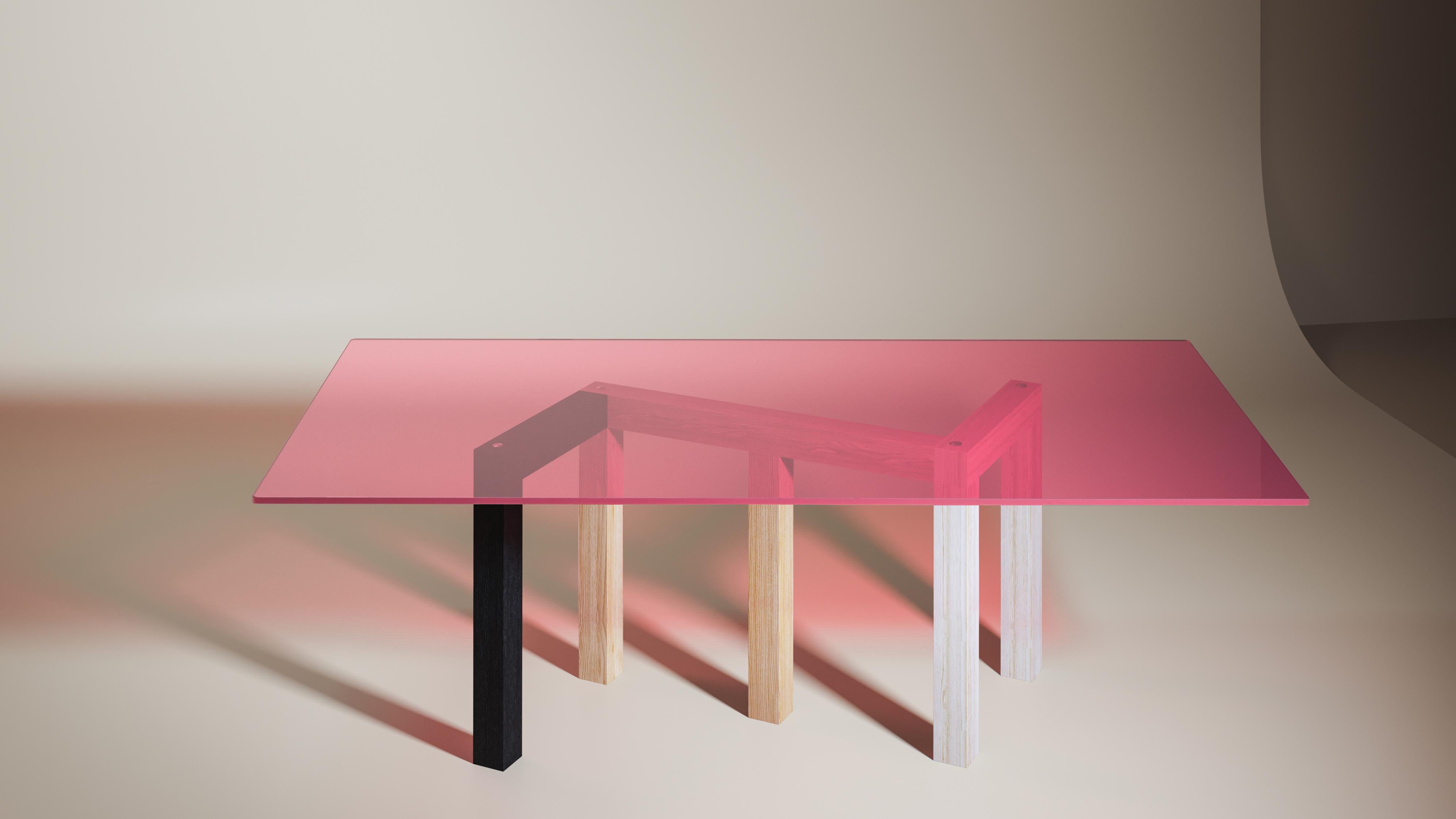 Penrose is a large dinner table in wood and glass. The design was inspired by the geometric research of mathematician Roger Penrose and his famous impossible triangle.
Depending on the point of view, the legs overlap or blend to form shapes with 3,