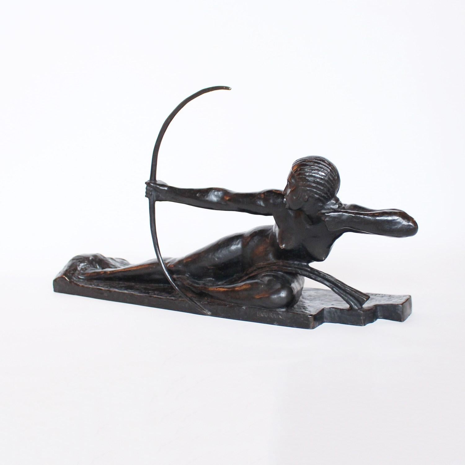 Penthesilia, Queen of the Amazons, an Art Deco patinated bronze sculpture set over a wooden plinth depicting the Queen of the Amazons drawing her bow. Signed Bouraine to cast. Susses Frères foundry mark and Cire Perdue mark.






    
