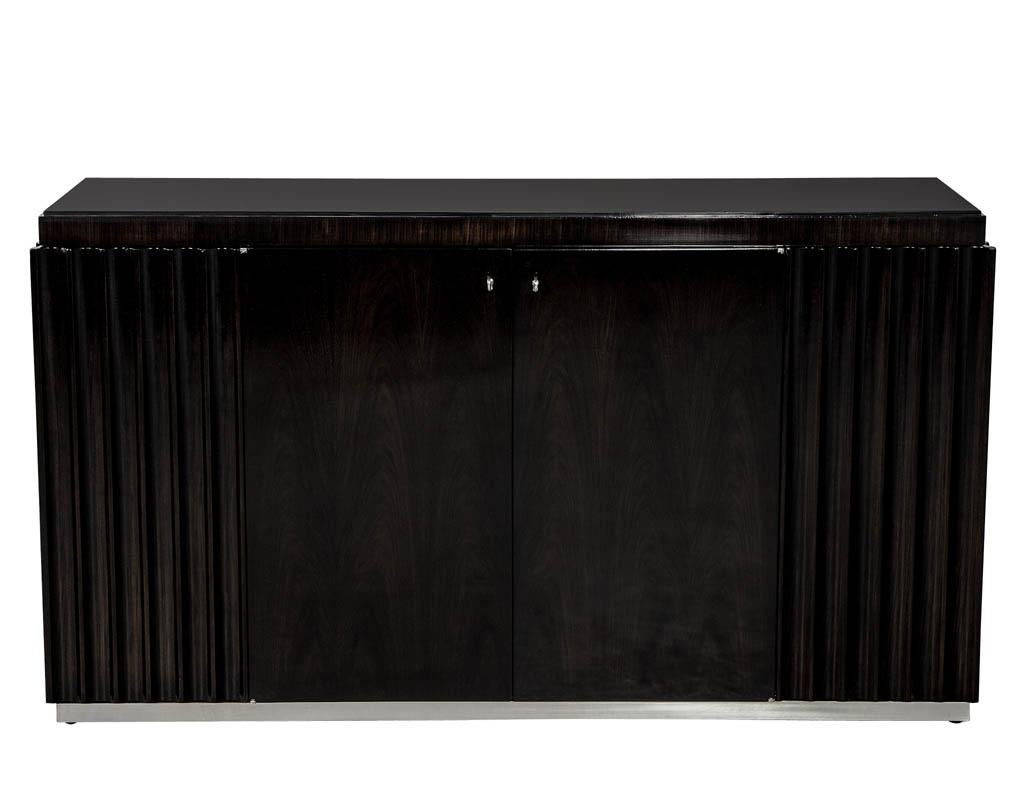 Penthouse fluted buffet sideboard by Ralph Lauren. Finished in a blackened walnut with polished stainless-steel base and hardware. Recently refinished by Carrocel.

Price includes complimentary curb side delivery to the continental USA.