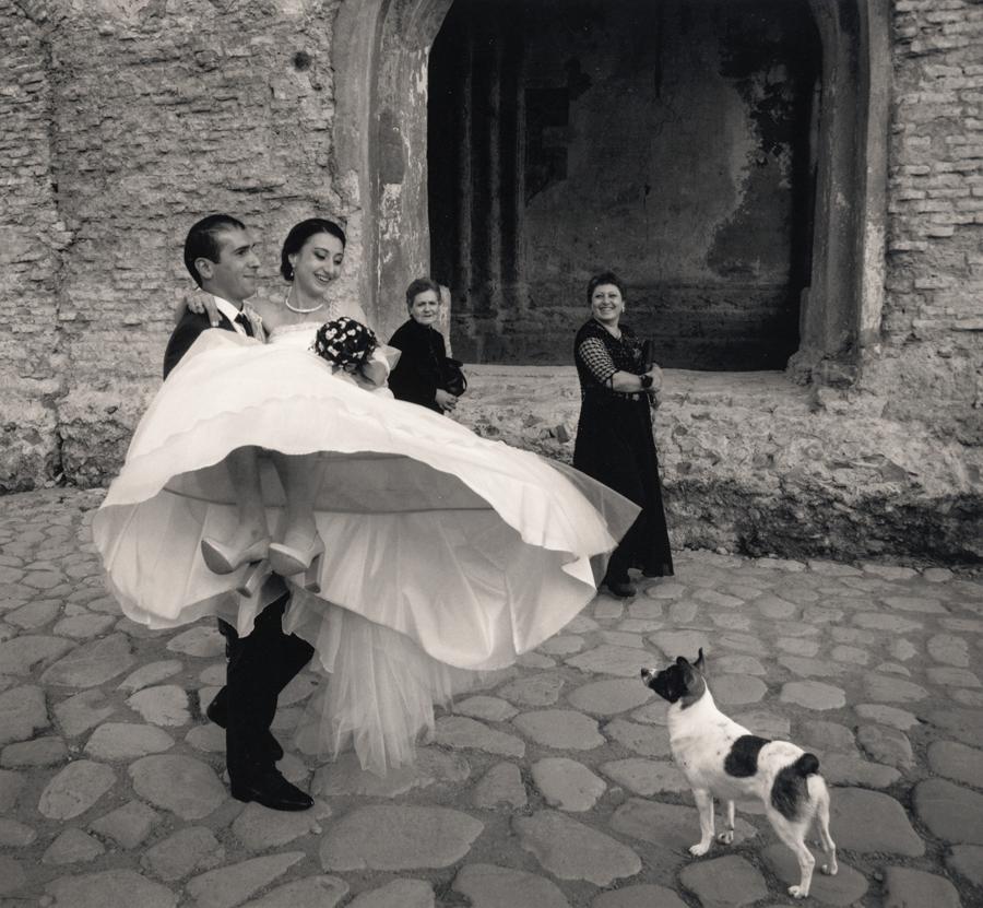 Pentti Sammallahti Black and White Photograph - Alaverdi, Georgia (Groom carrying Bride, spotted dog watching)