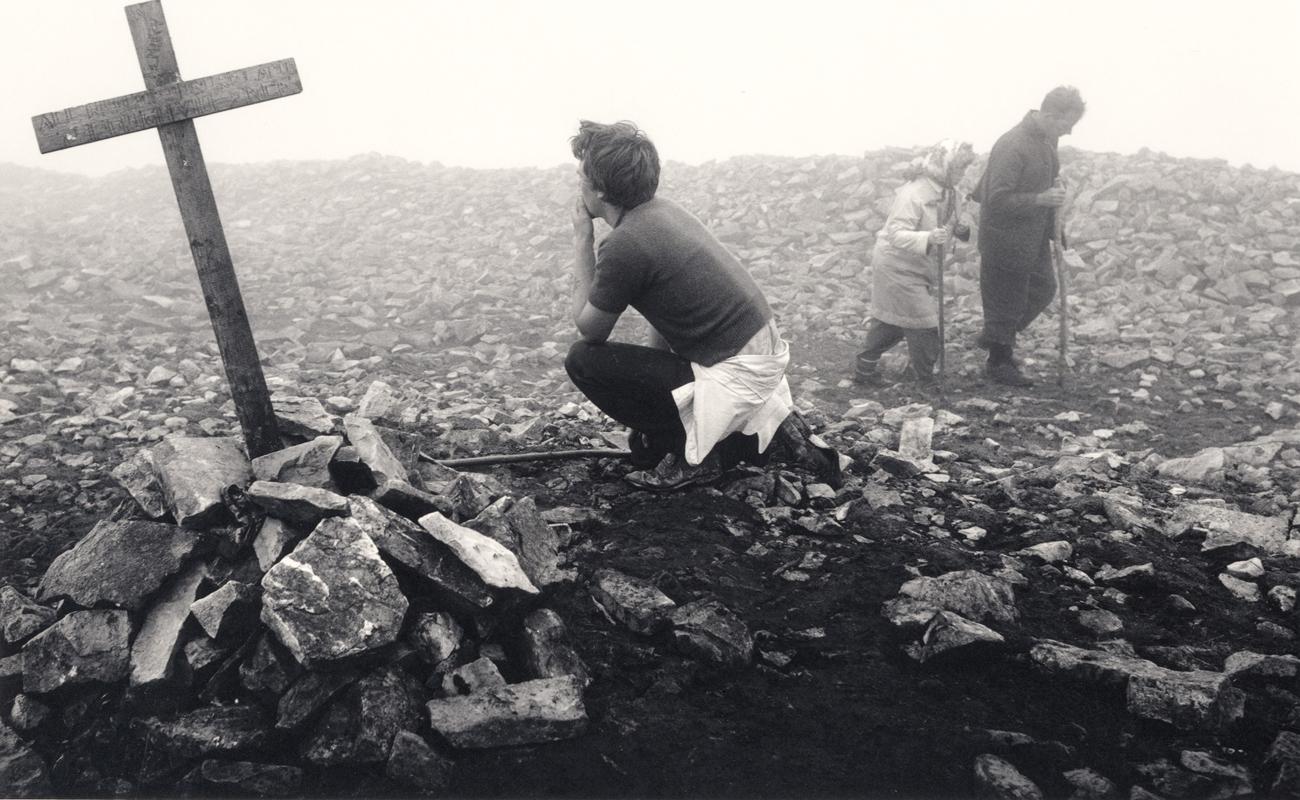 Pentti Sammallahti Black and White Photograph - Croagh Patrick, Ireland (Boy Kneeling by Cross)