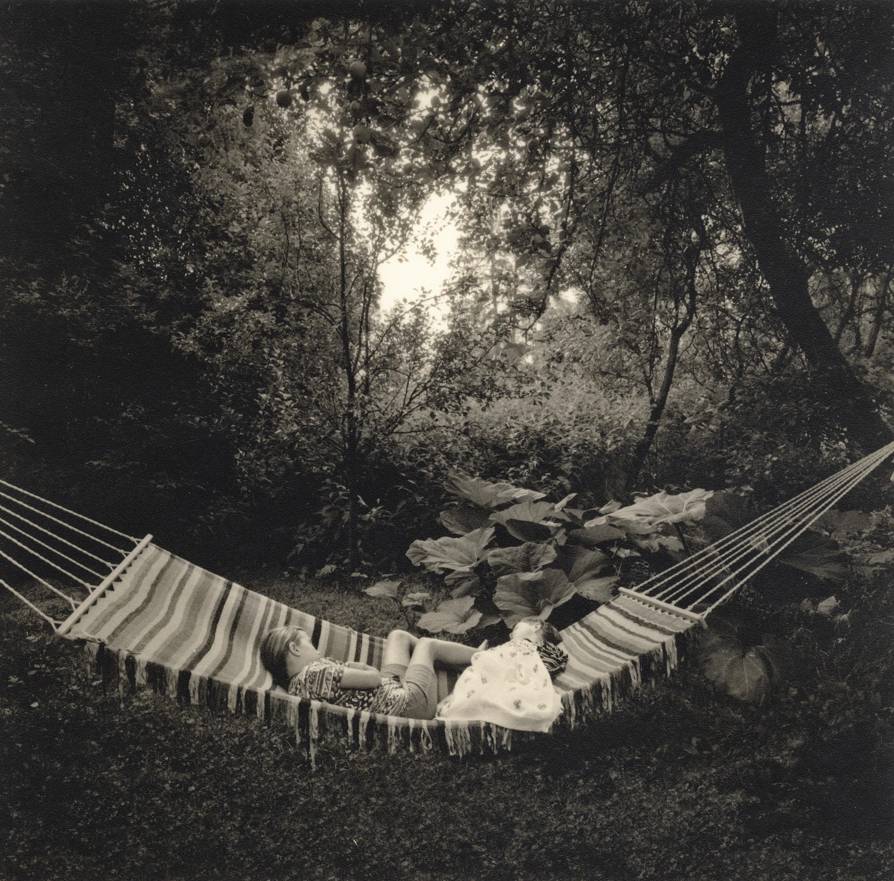 Pentti Sammallahti Landscape Photograph - Kemio, Finland (Children laying in hammock in lush garden)