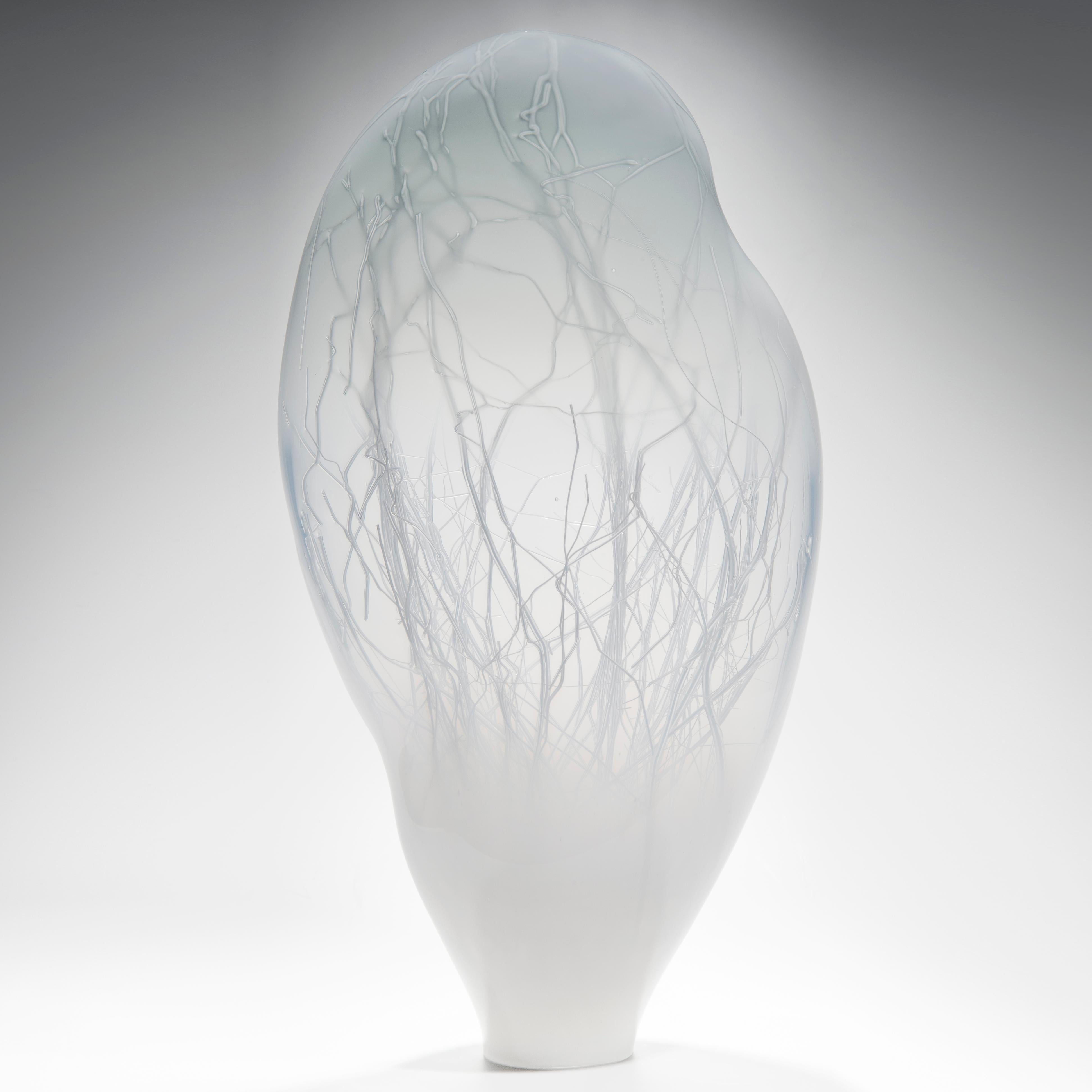 Penumbra in Grey is a unique glass sculpture in white and soft dove grey coloured glass by the collaborative artists Hanne Enemark (Danish) and Louis Thompson (British). The outer glass form contains a multitude of fine white canes of glass. Before