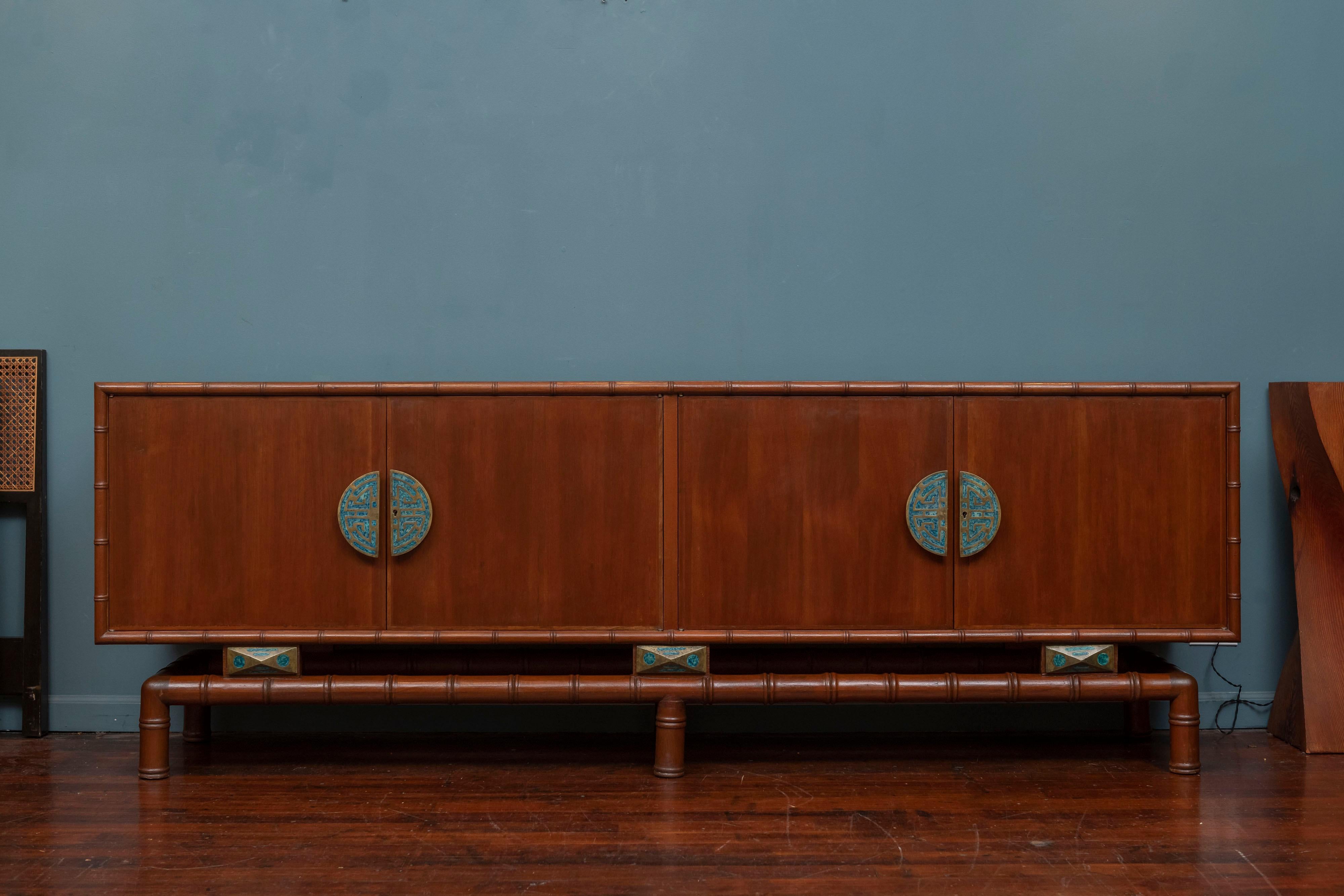 Frank Kyle and Pepe Mendoza design credenza, Mexico circa 1960. 
Rare and impressive credenza or cabinet with a faux bamboo base and door trim with four large locking doors, drawers and interior shelf. 
Mounted with large Pepe Mendoza crafted