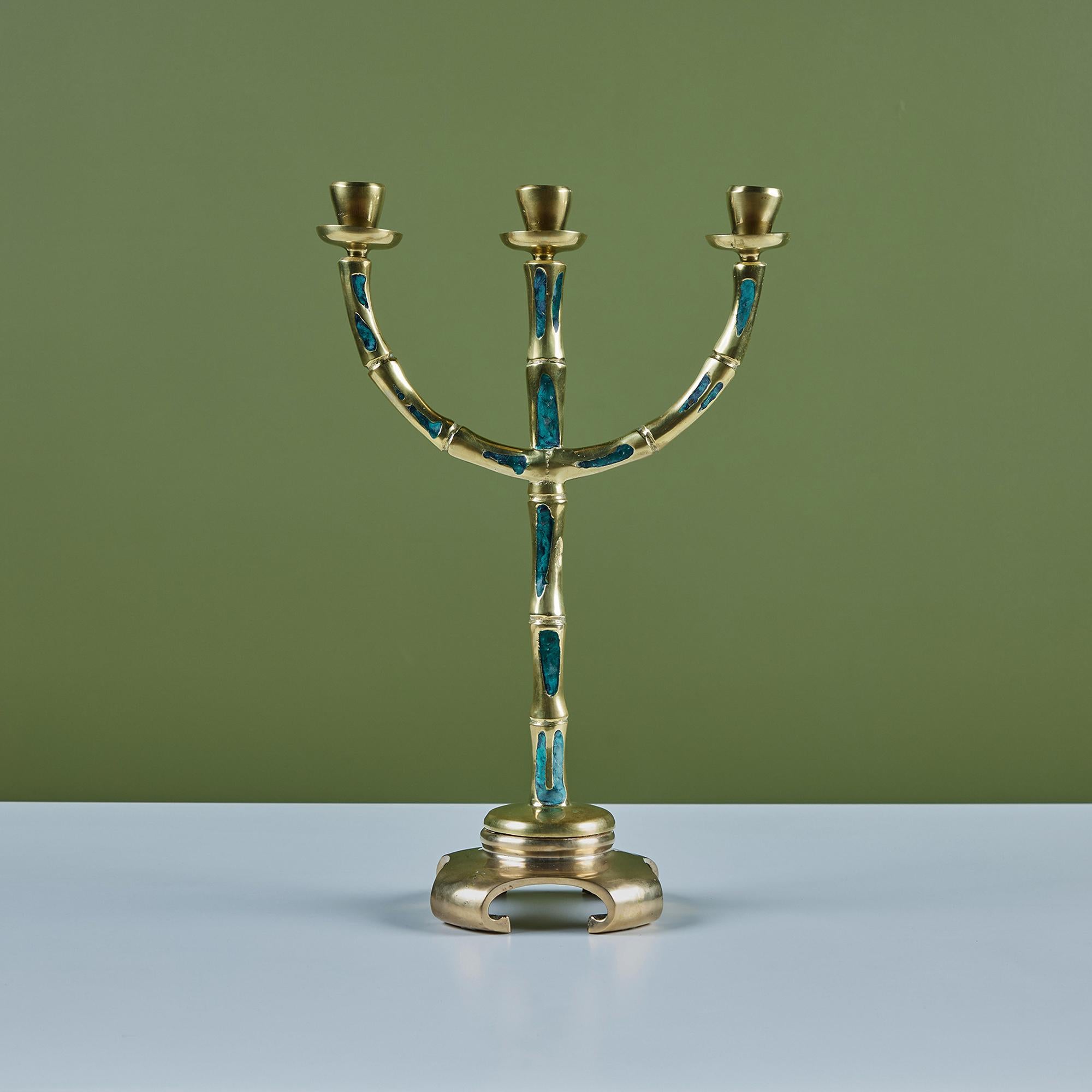 José Mendoza ran a foundry called Pepe Mendoza in the 1950s and 60s in Mexico City, manufacturing modernist home accessories using a modified cloisonné technique more suited to the tastes of the day. This brass candelabra features three arms and the