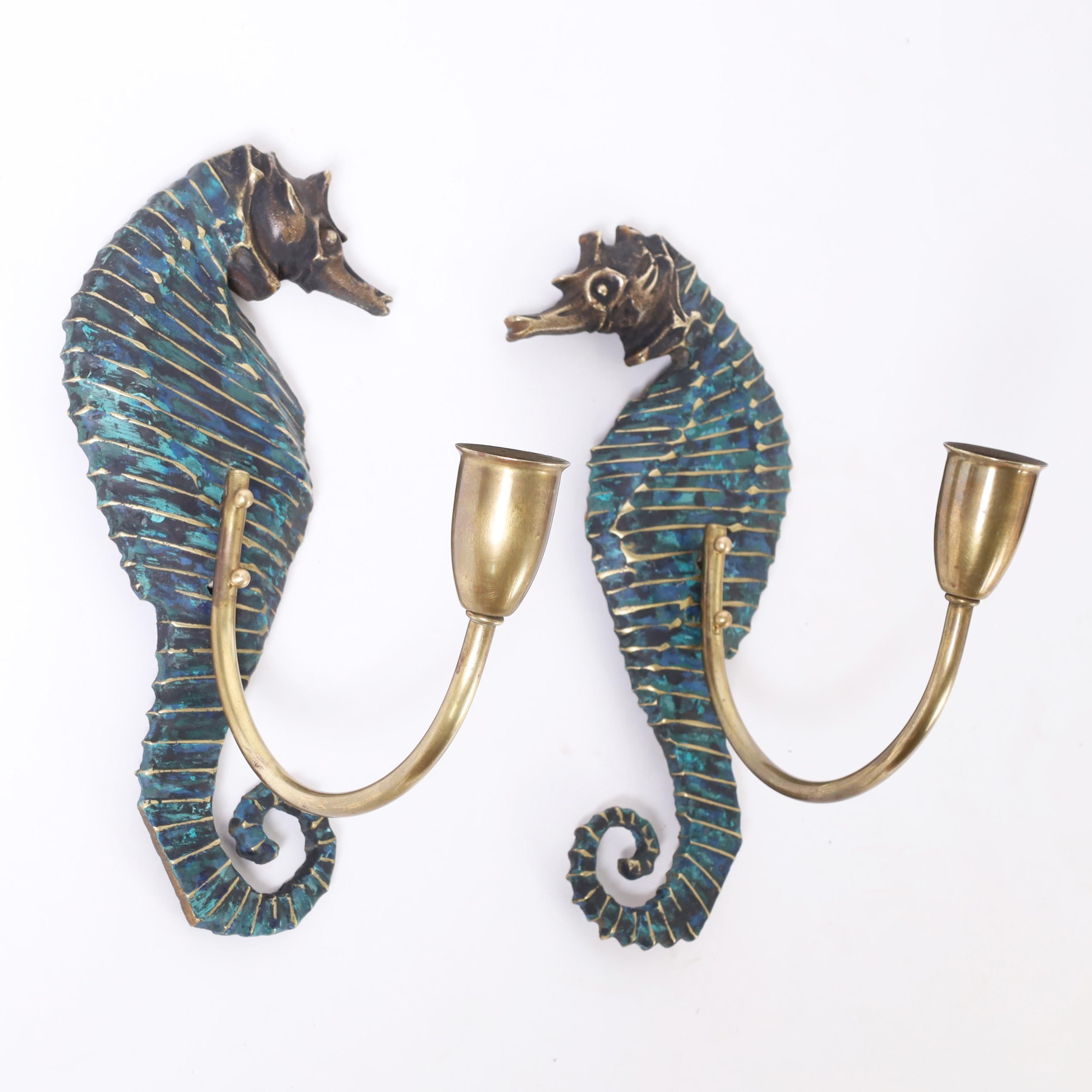 Vintage pair of seahorse wall sconces cast in bronze in a stylized modern form, painted in an alluring blue with brass arms. Signed Mendoza Mexico on the back. 