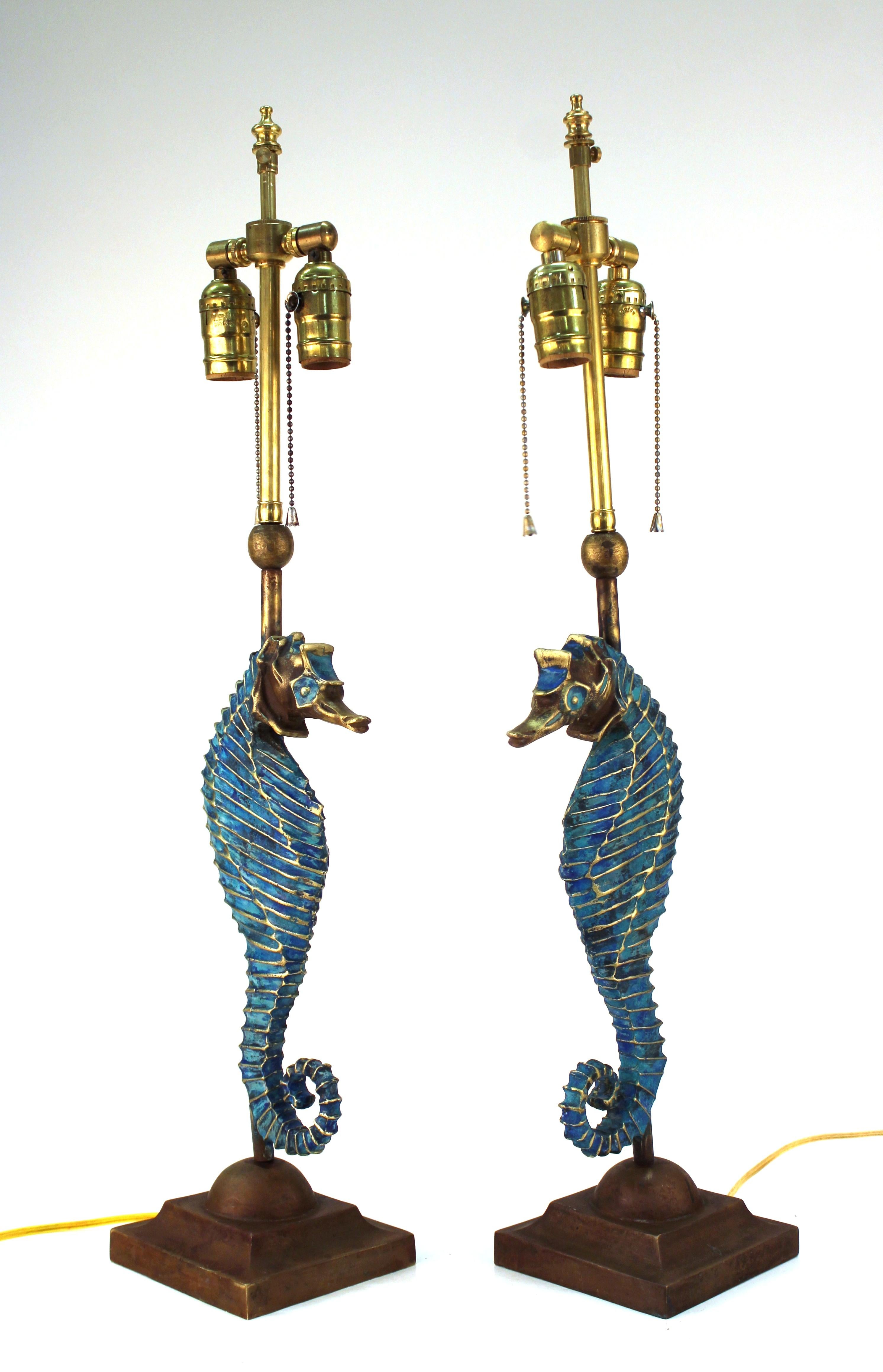 Pair of Pepe Mendoza style Mid-Century Modern table lamps in the shape of blue seahorses on square bases, each bearing the makers mark and patent. The pair has recently been rewired to meet standards and has extendable harps on top. In excellent