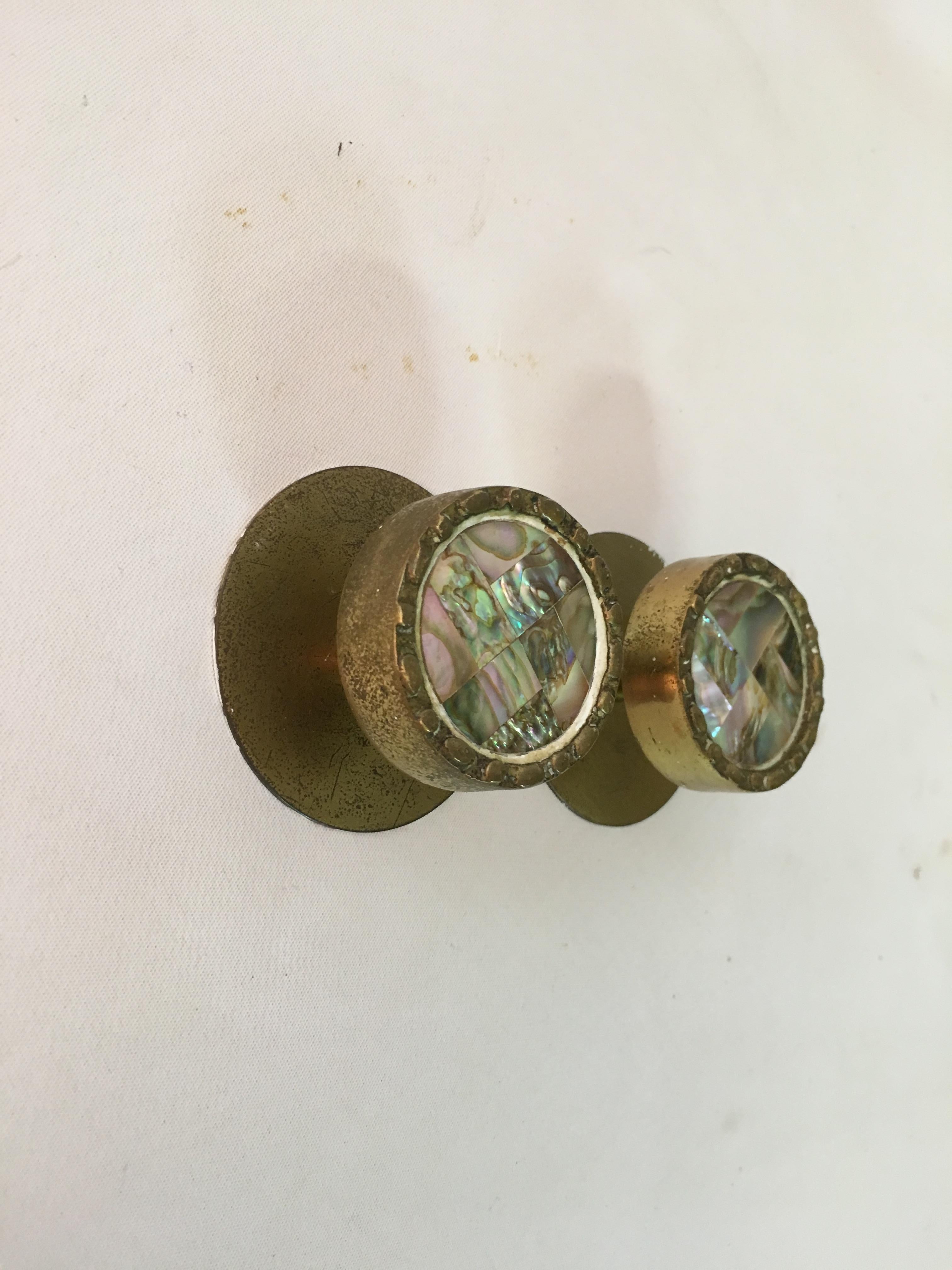 Pair of cast brass and Abalone hardware pulls in the style of Pepe Mendoza. Abalone mosaic inserts surrounded by brass. Signed on back with Japan and Mexico die stamps. circa 1960. 


Round dimensions are 1.5