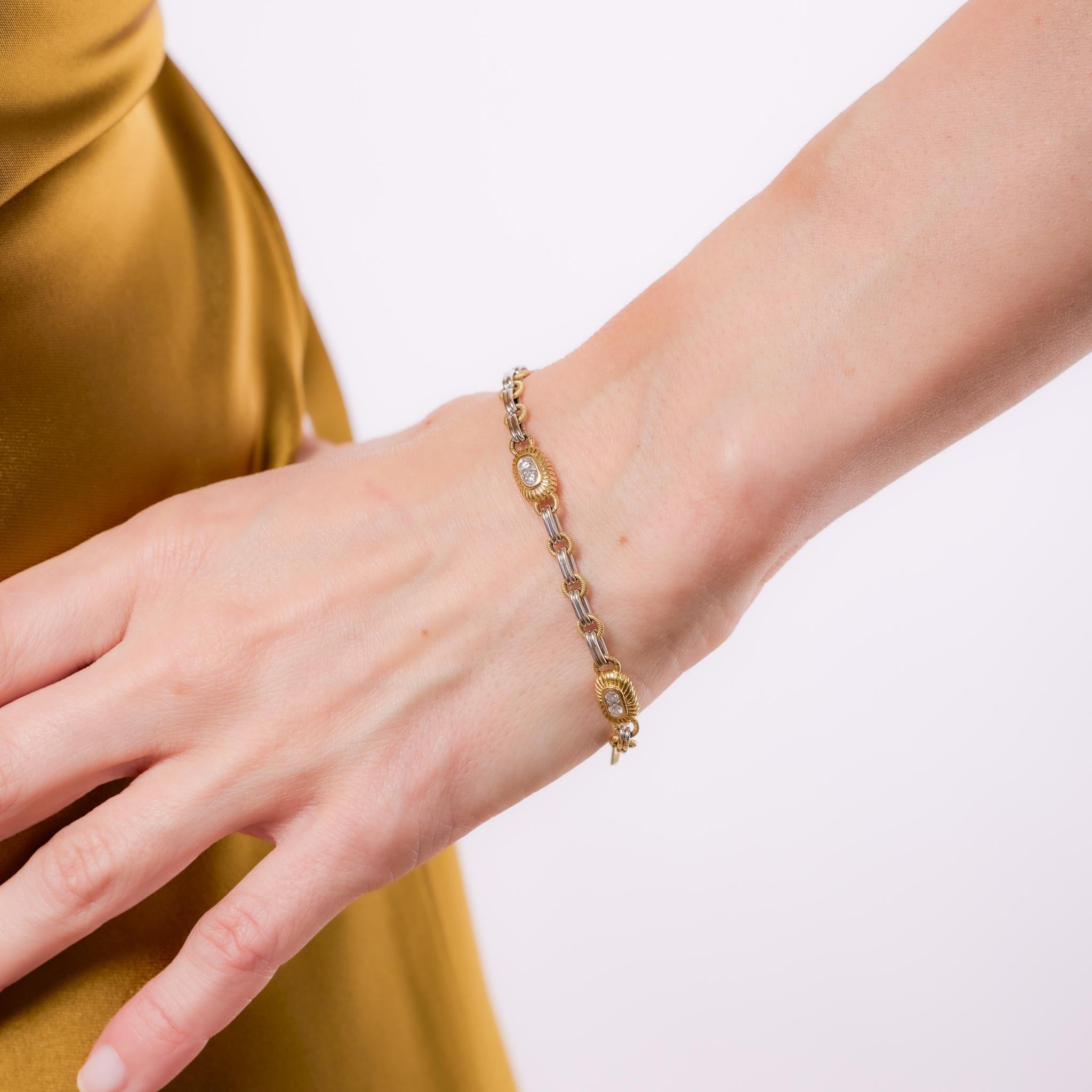 Crafted in the 1990s, this vintage Pepi bracelet showcases a chic mixed-metal design in 18k yellow and white gold. It features 16 round brilliant cut diamonds totaling approximately .35 carats, graded F-G color and VS clarity, adding refined sparkle