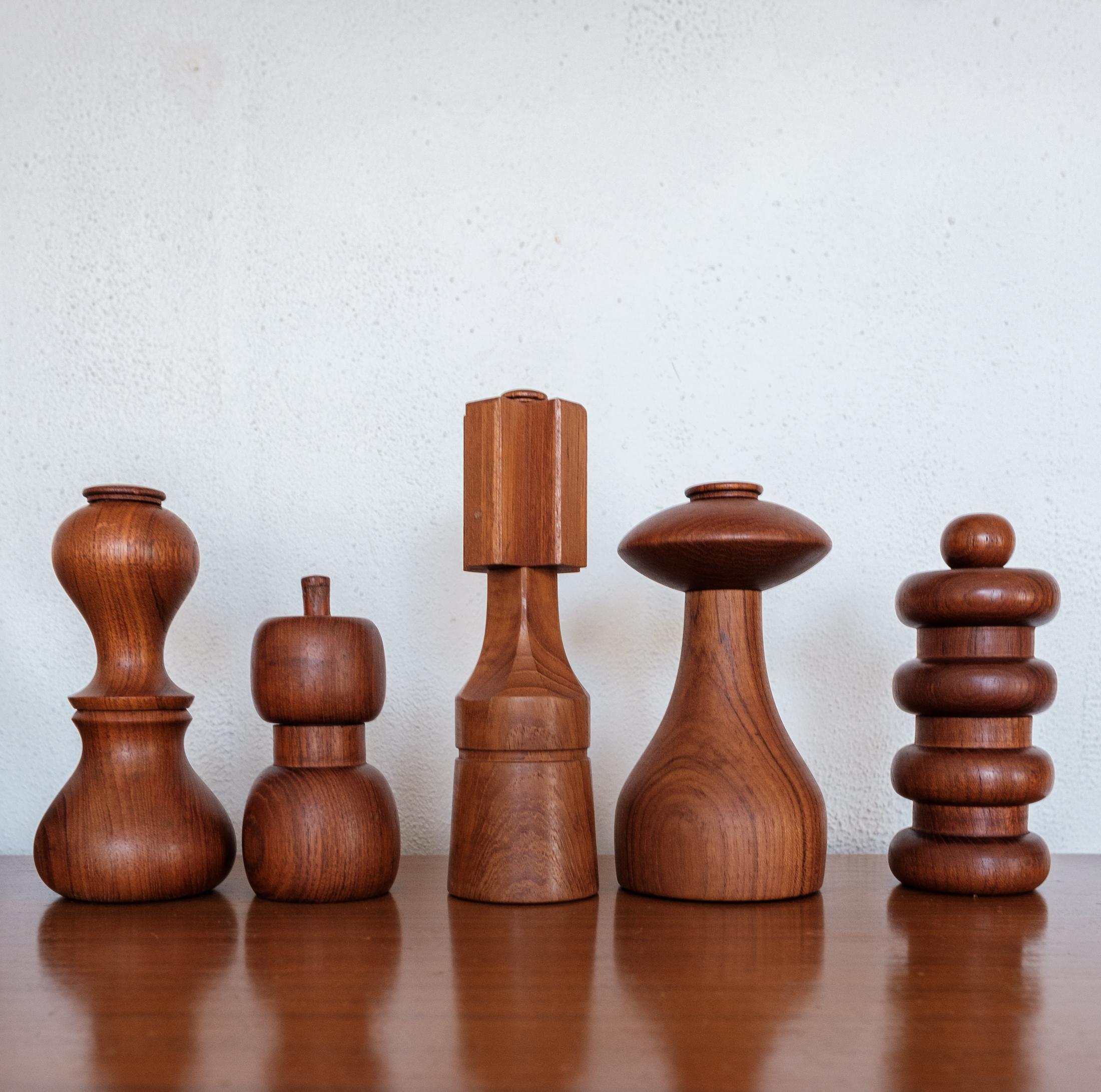 Collection of five teak pepper mills by Jens Quistgaard. Early metal grinding mechanisms produced by Peugeot. The mills were produced by Dansk in Denmark, circa 1960s. 

 