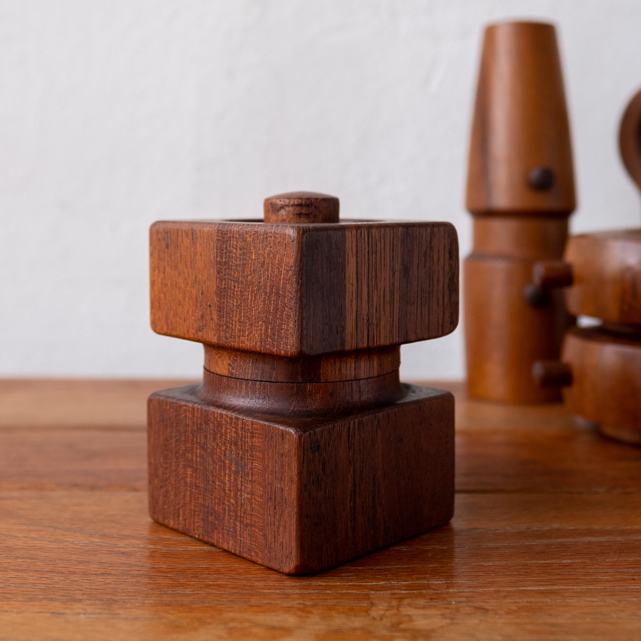 Collection of four teak pepper mills by Jens Quistgaard. Most are early metal grinding mechanisms produced by Peugeot. The mills were all produced by Dansk in Denmark, circa 1960s. 

 
