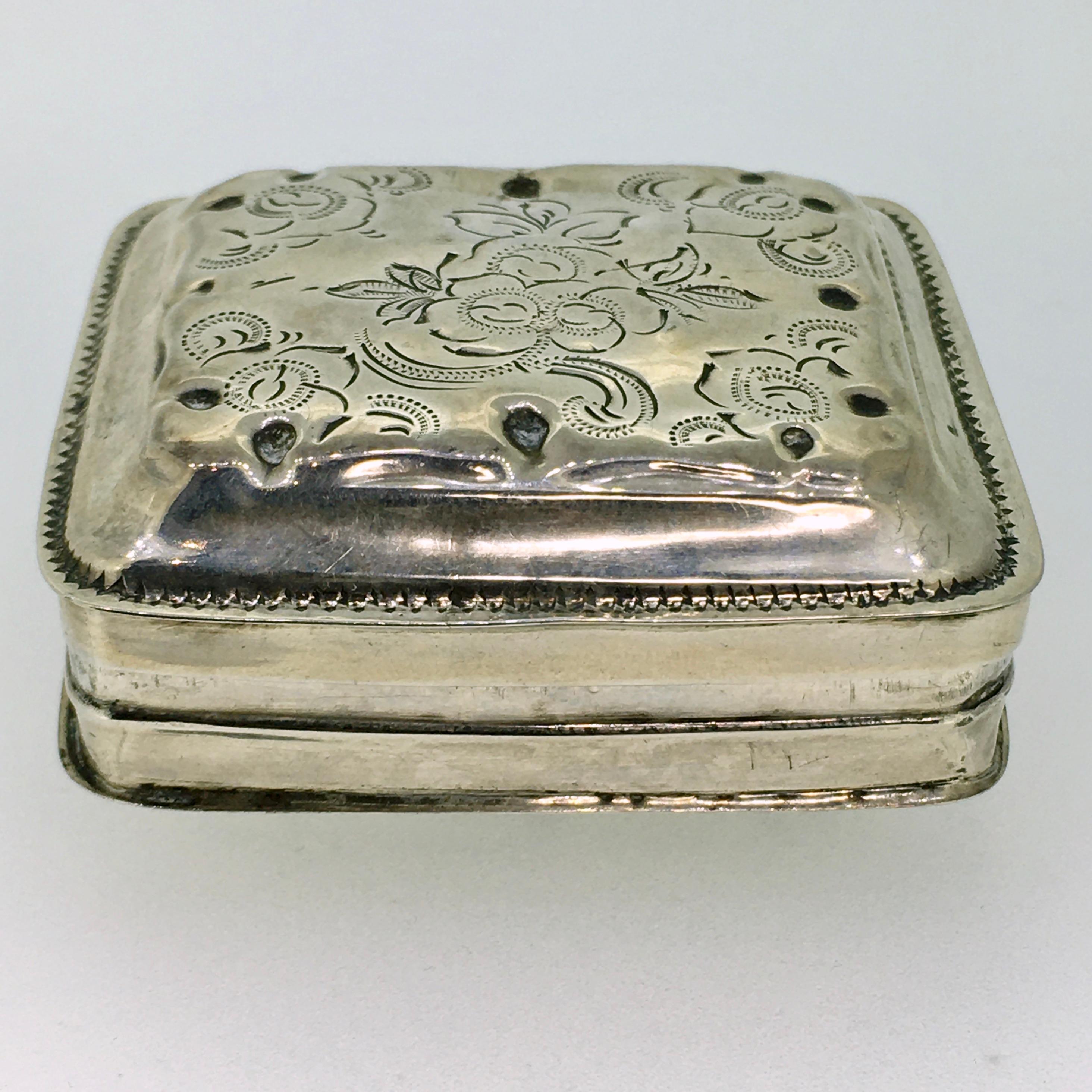 The antique silver Peppermint box, Dutch Biedermeier, Handengraved. This antique peppermint box is of the square contoured type with a hinged lid. The Biedermeier floral engraving confirms the age of this small masterpiece.  Profile edge and rib