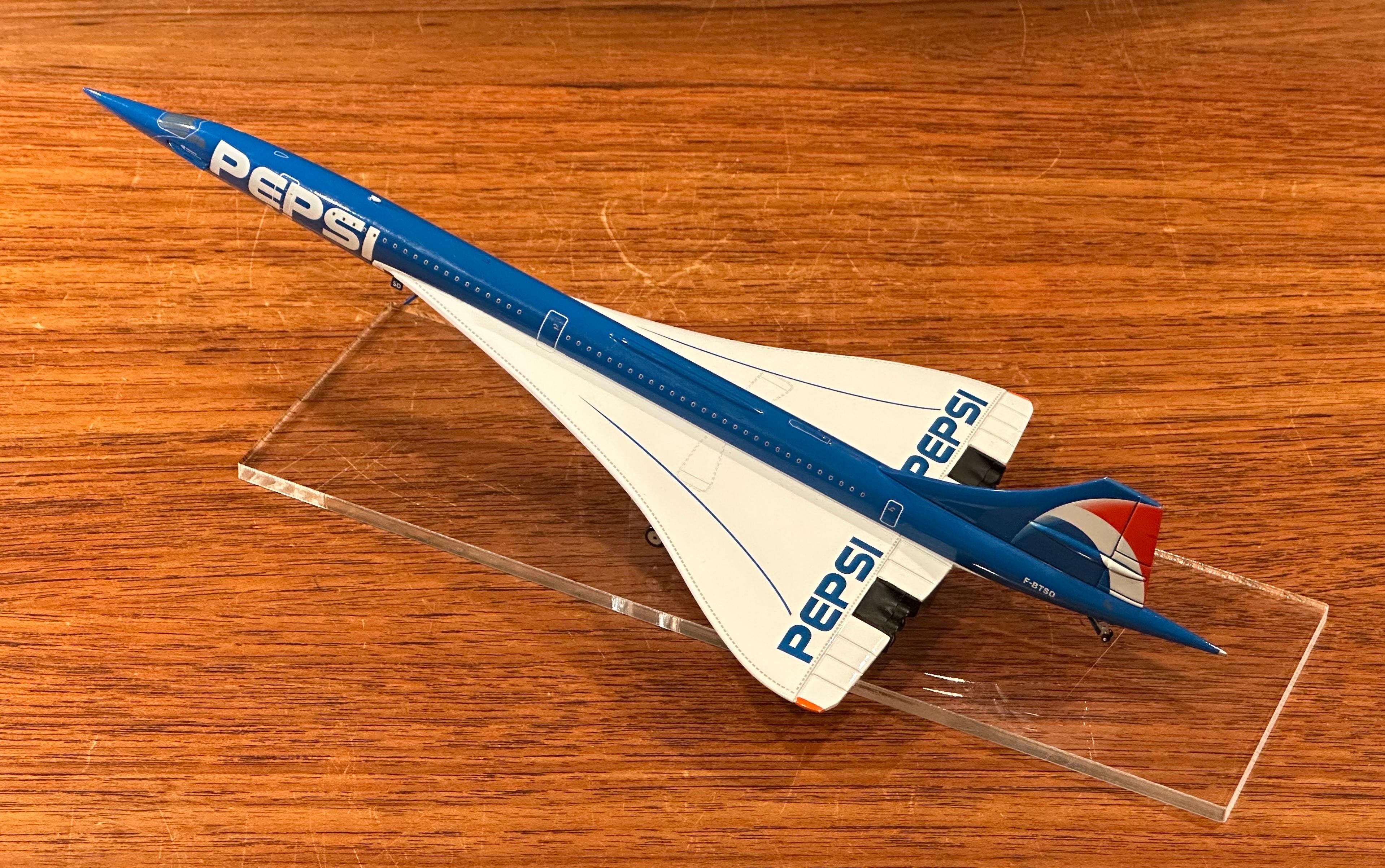 A very cool Pepsi logoed Concorde jetliner desk model on lucite base, circa late 1990s.  The model measures 5.5