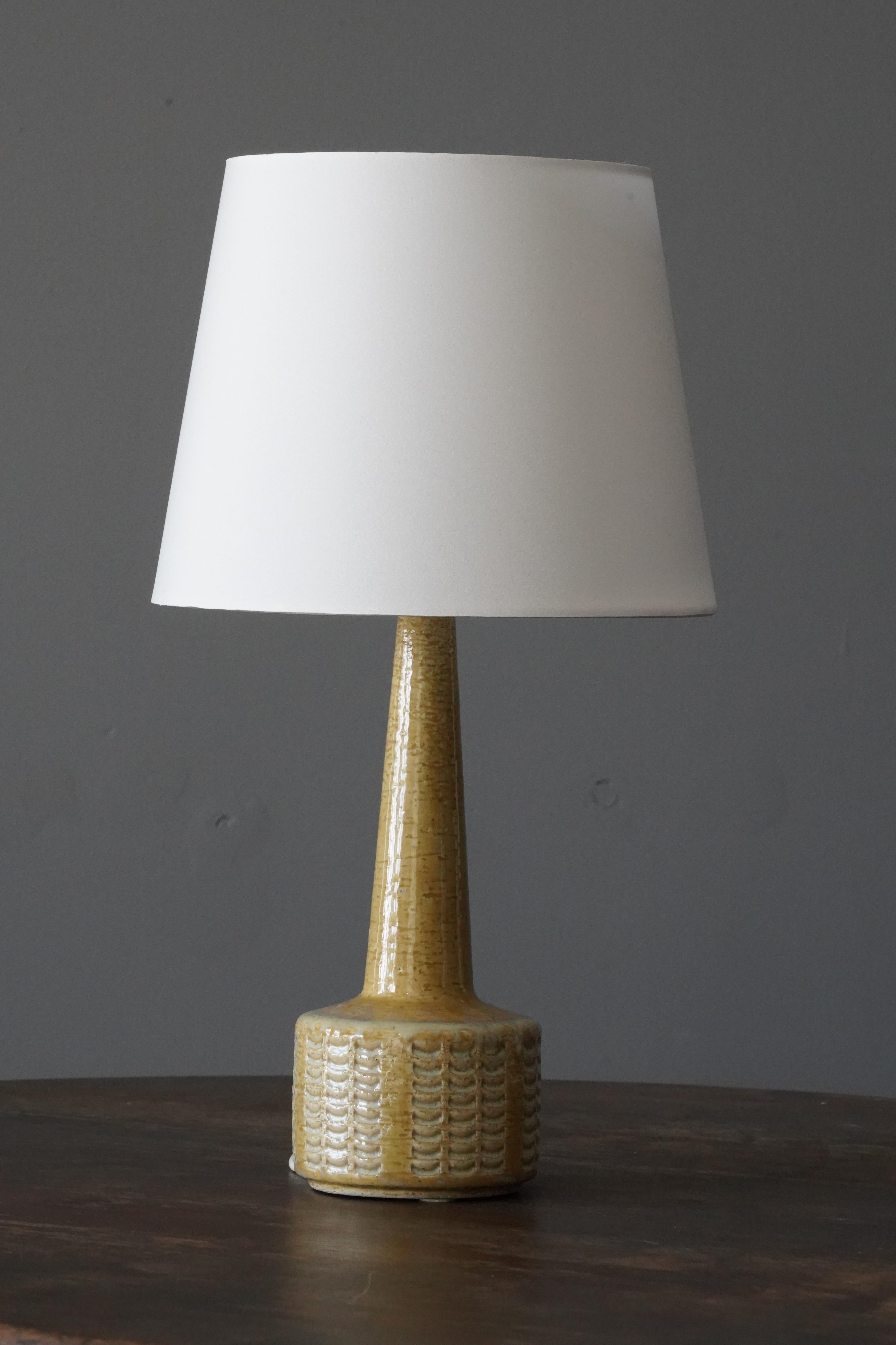 A table / desk lamp designed by husband and wife Per & Annelise Linneman-Schmidt. Handcast in firesand. Produced in their own Studio, named Palshus, in Sengeløse, Denmark. Signed. Features simple incised ornamentation.

Sold without lampshade.
