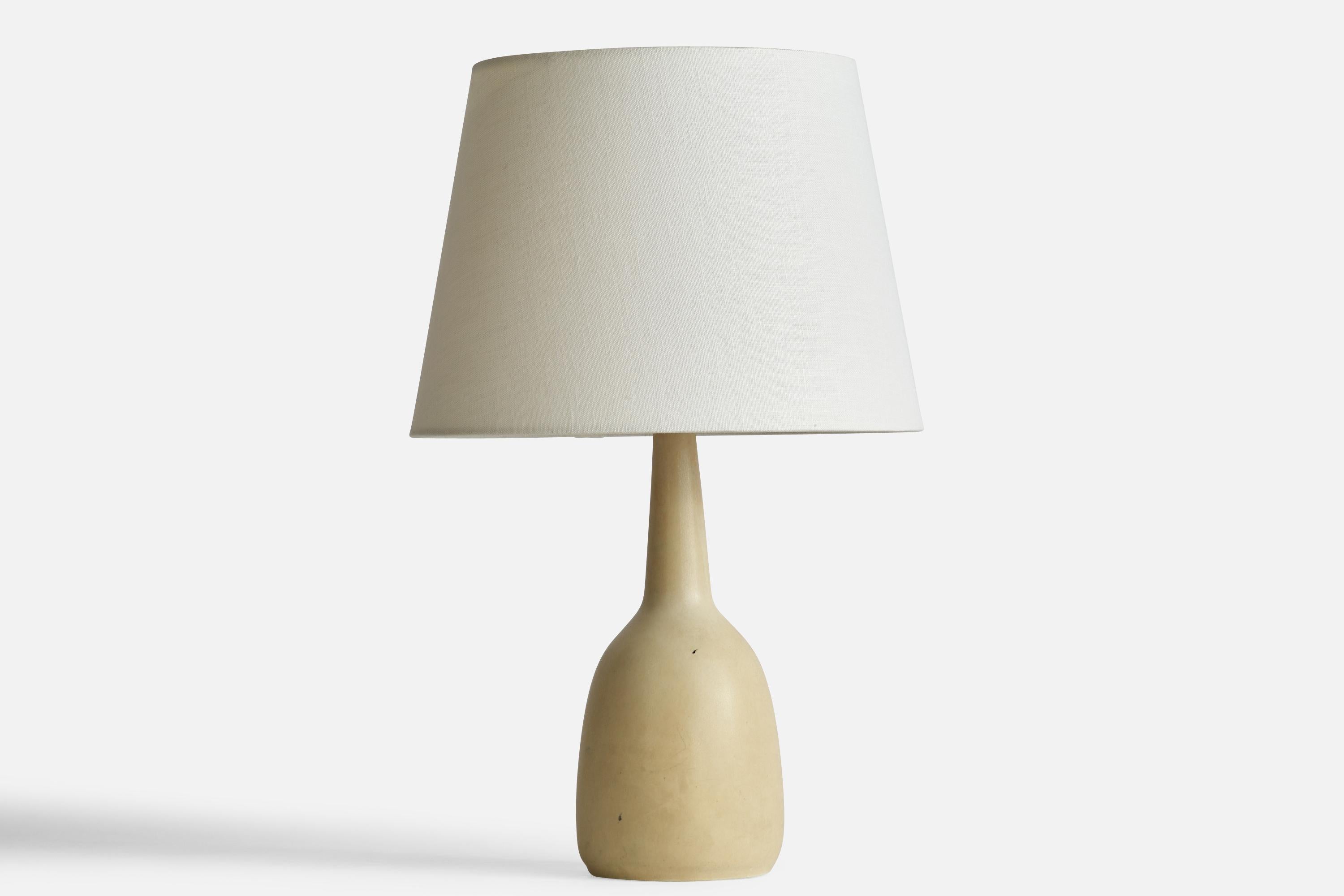 A beige-glazed stoneware table lamp designed by Per & Annelise Linneman-Schmidt and produced by Palshus, Denmark, 1960s.

Dimensions of Lamp (inches): 13.75” H x 5” Diameter
Dimensions of Shade (inches): 9” Top Diameter x 12” Bottom Diameter x 9”