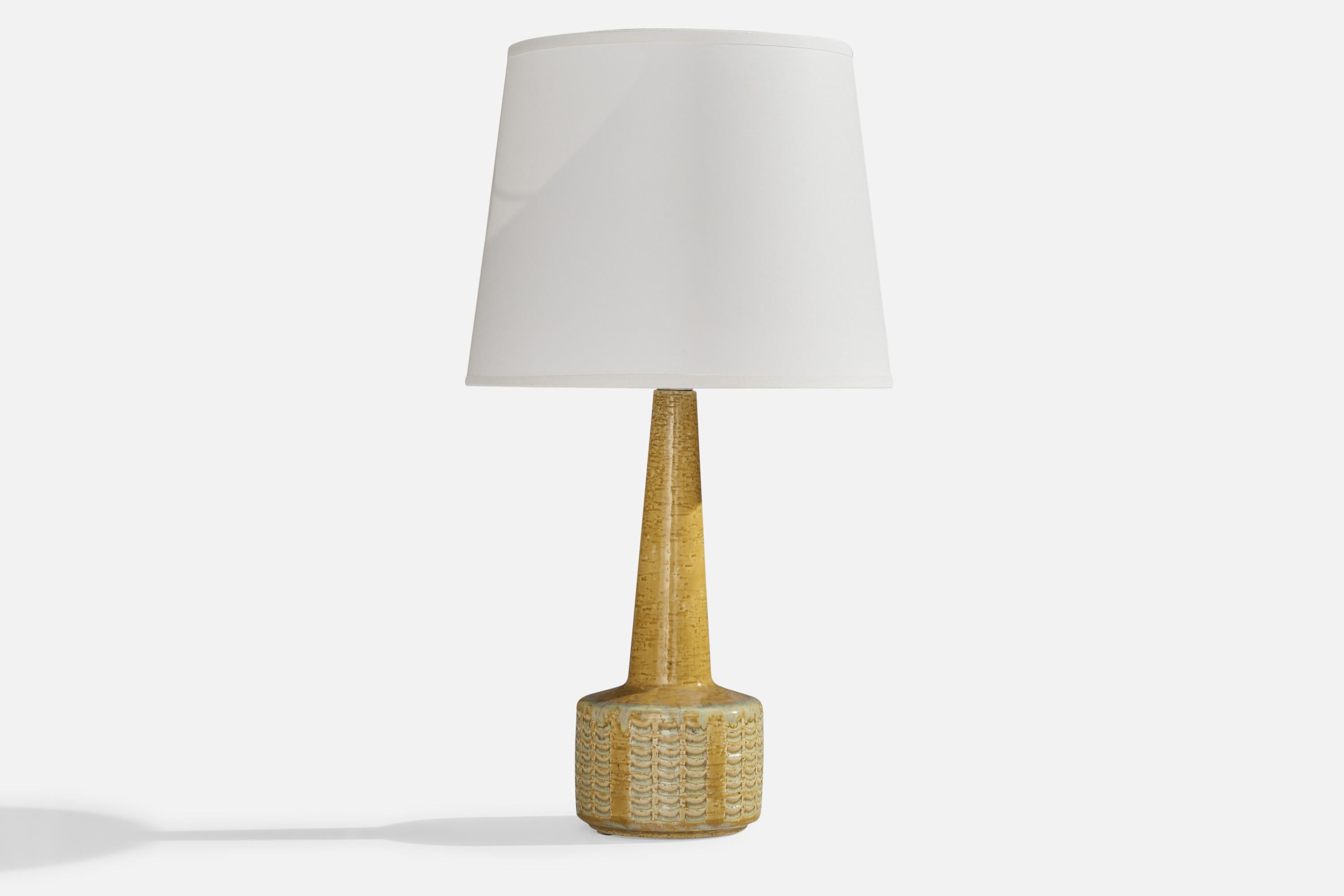 A yellow-glazed stoneware table lamp designed by Per & Annelise Linneman-Schmidt and produced by Palshus, Denmark, 1960s.

Dimensions of Lamp (inches): 13”  H x 4.4”  Diameter
Dimensions of Shade (inches): 7”  Top Diameter x 10” Bottom Diameter x 8”