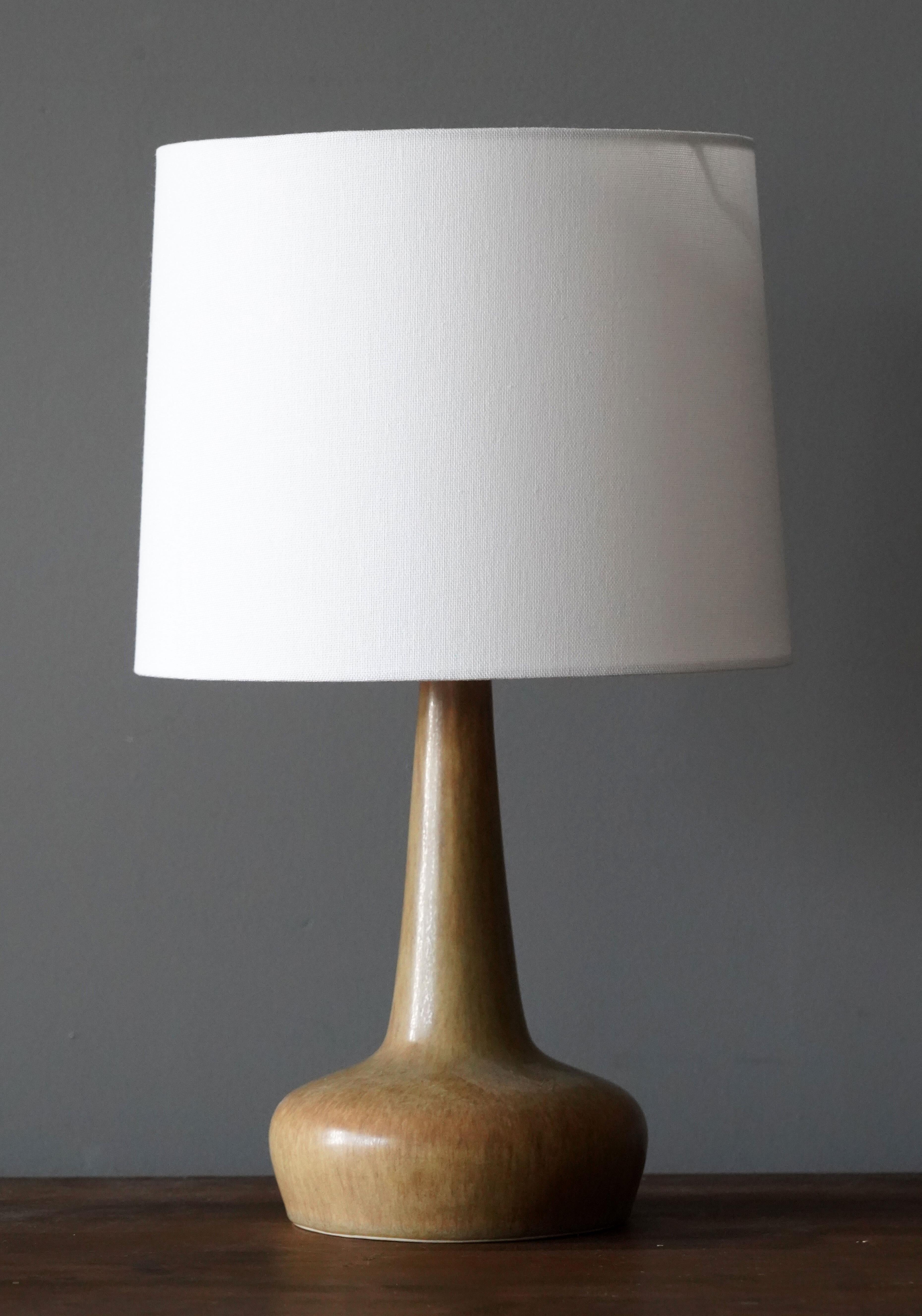 A table / desk lamp designed by husband and wife Per & Annelise Linneman-Schmidt. Hand cast in firesand. Produced in their own Studio, named Palshus, in Sengeløse, Denmark. Signed.

The lampshade is attached for reference and not included in the