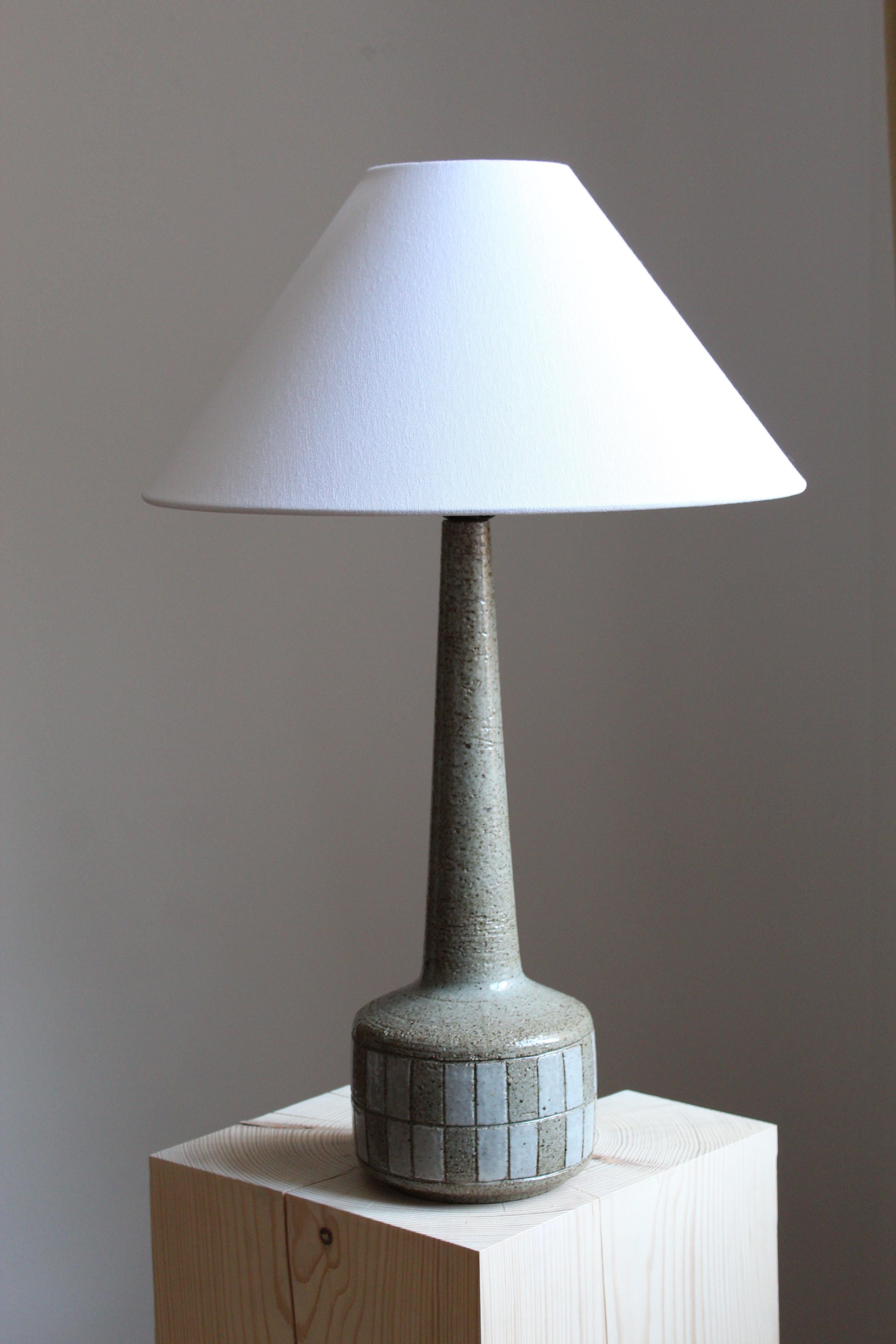 A large table / desk lamp designed by husband and wife Per & Annelise Linneman-Schmidt. Handcast in firesand. Produced in their own Studio, named Palshus, in Sengeløse, Denmark. Signed.  Lampshade not included.

Glaze features grey-brown