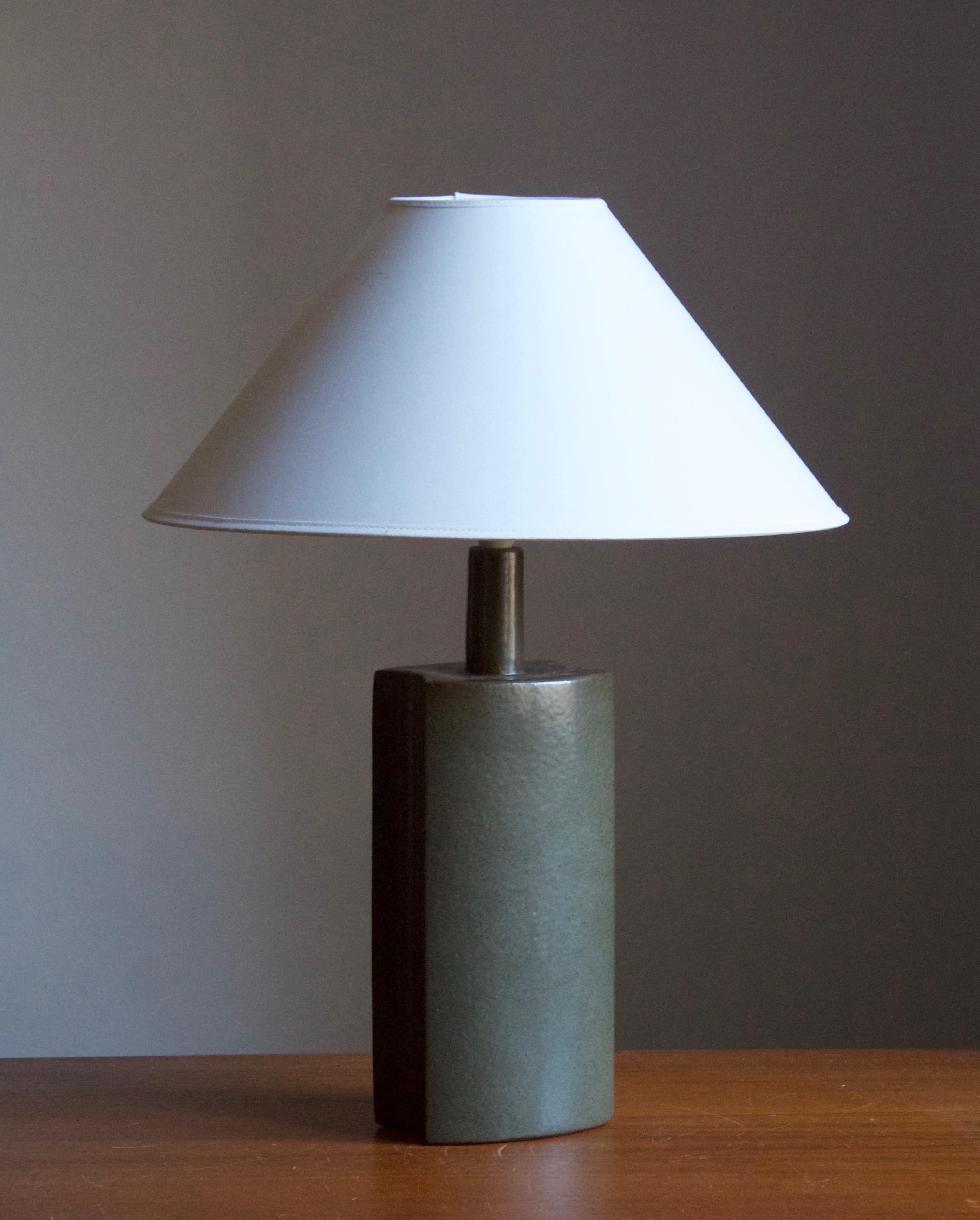 A table / desk lamp designed by husband and wife Per & Annelise Linneman-Schmidt. Handcast in stoneware, green glaze. Produced in their own Studio, named Palshus, in Sengeløse, Denmark. Signed.

Sold without lampshade. Stated dimensions exclude