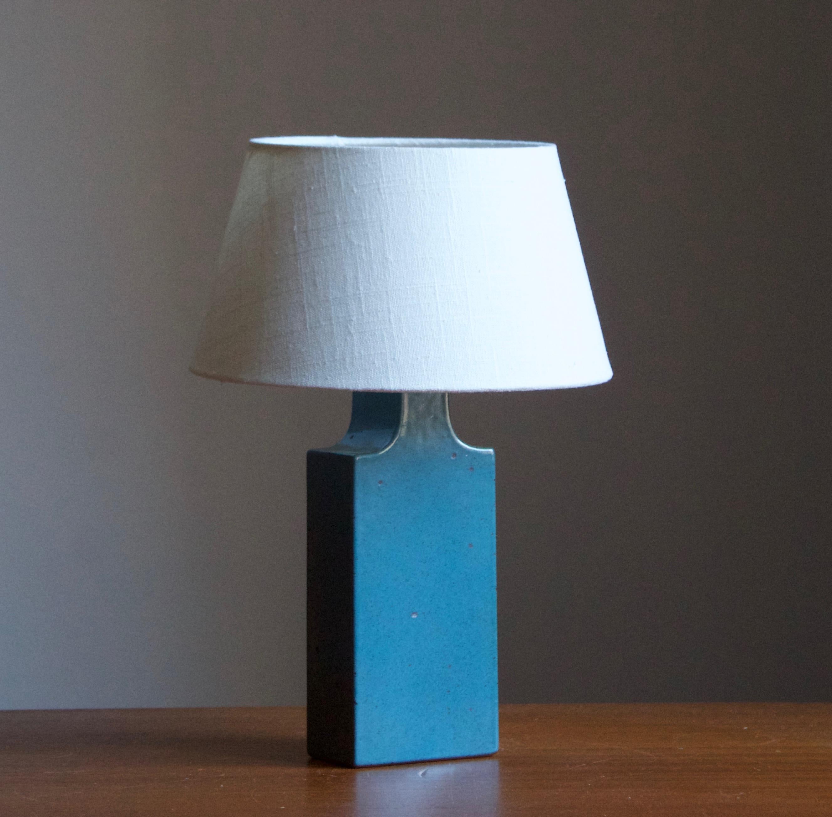 A table / desk lamp designed by husband and wife Per & Annelise Linneman-Schmidt. Handcast in stoneware, blue glaze. Produced in their own Studio, named Palshus, in Sengeløse, Denmark. Signed.

Sold without lampshade. Stated dimensions exclude