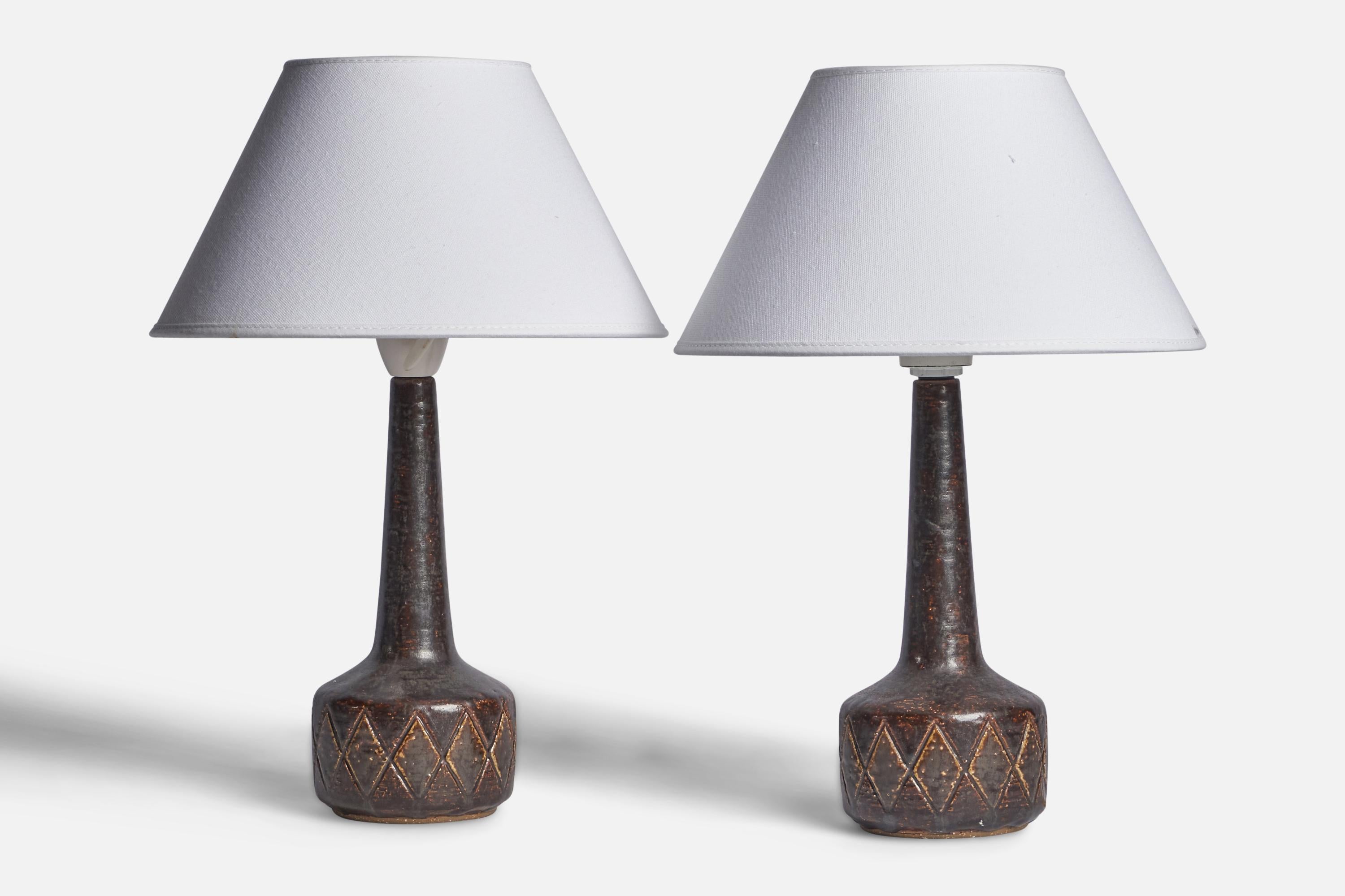 A pair of brown-glazed incised stoneware table lamps designed by Per & Annelise Linneman-Schmidt and produced by Palshus, Denmark, 1960s.

Dimensions of Lamp (inches): 11” H x 4” Diameter
Dimensions of Shade (inches): 4.5” Top Diameter x 10” Bottom
