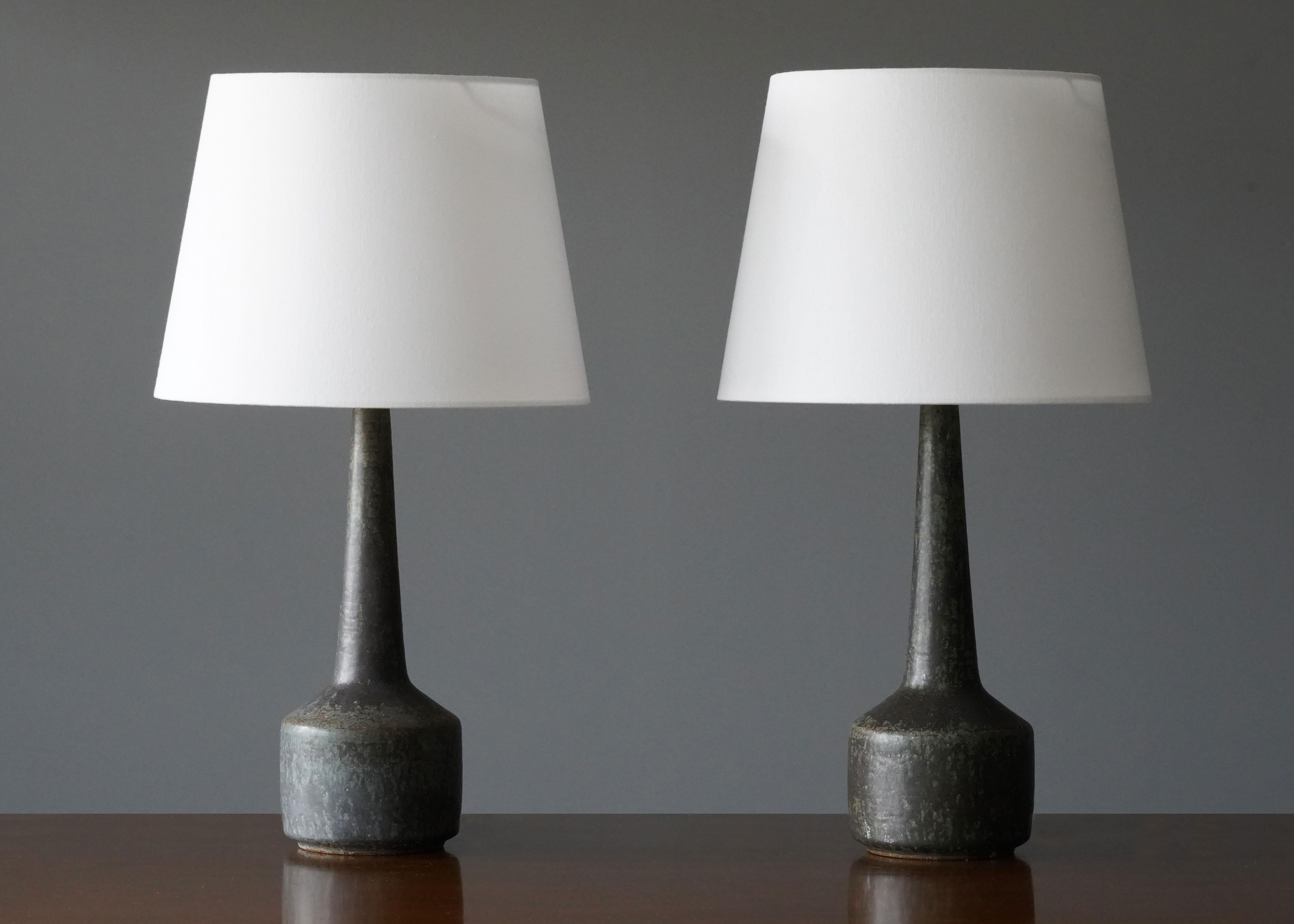 A pair of DL/35 table / desk lamps designed by husband and wife Per & Annelise Linneman-Schmidt. Handcast in firesand, each lamp with a unique glaze. Produced in their own Studio, named Palshus, in Sengeløse, Denmark.

This pair of early