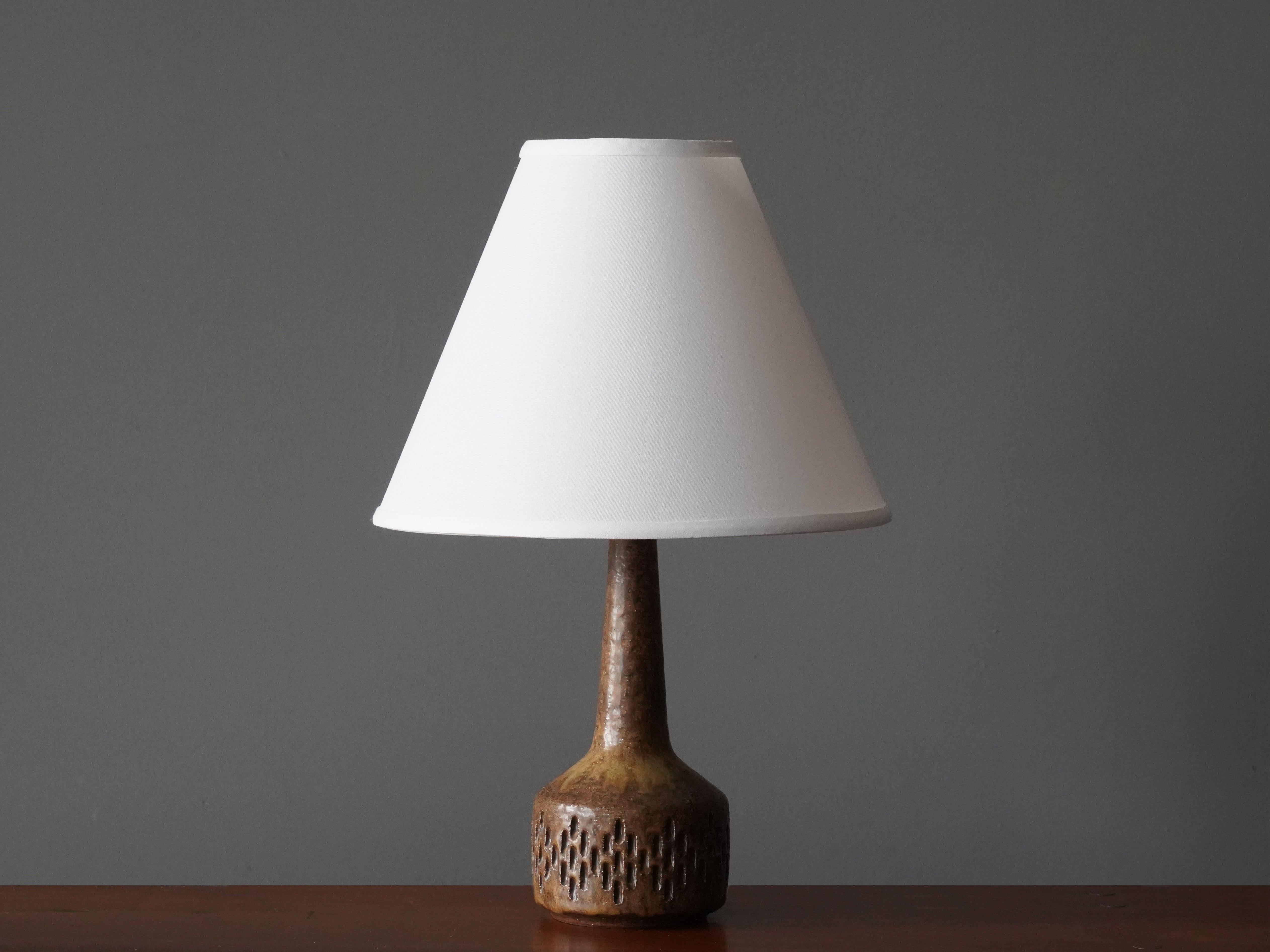A table / desk lamp designed by husband and wife Per & Annelise Linneman-Schmidt. Handcast in firesand, each lamp with a unique glaze. Produced in their own Studio, named Palshus, in Sengeløse, Denmark. Signed

This lamp of early production,