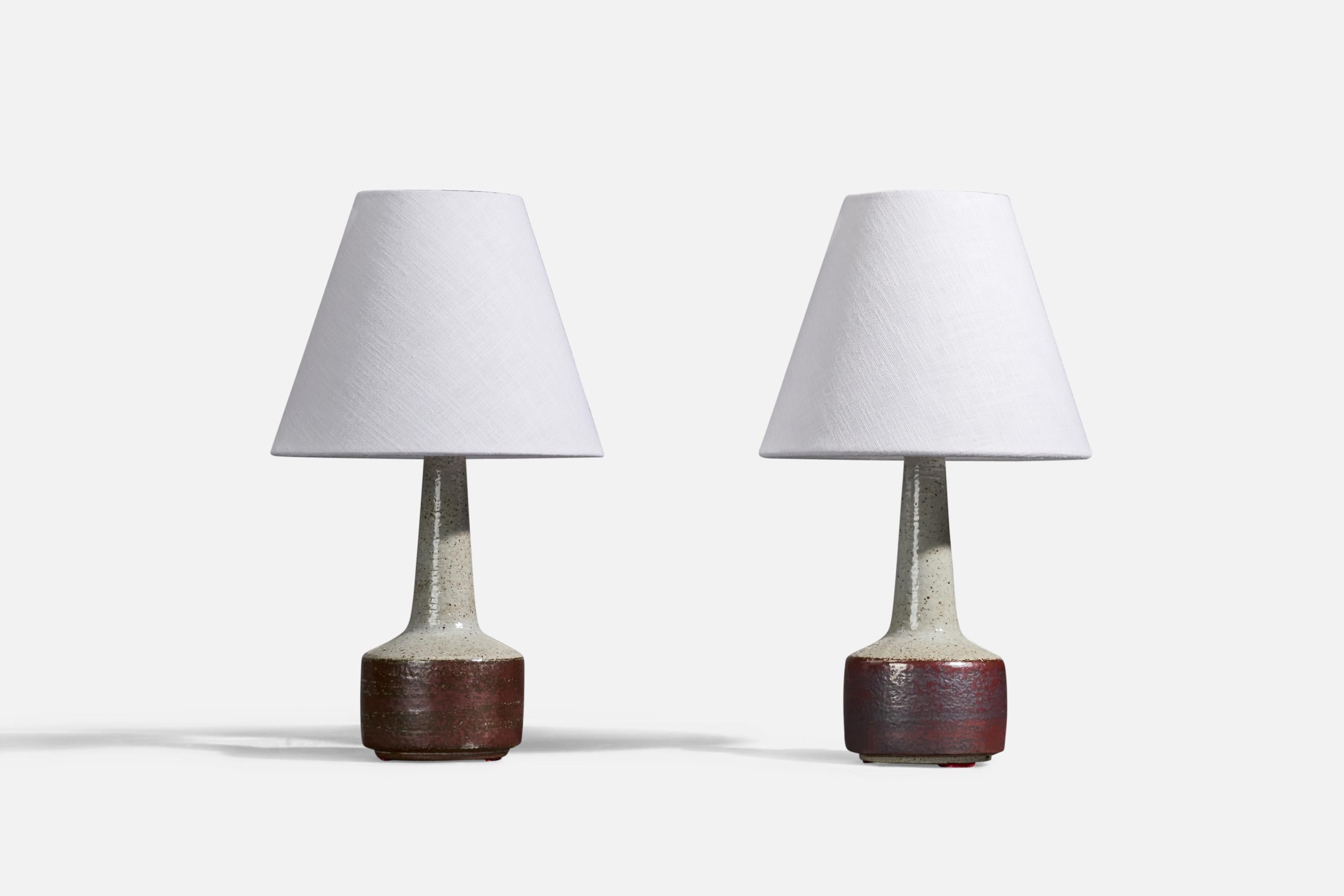 A pair of ceramic table lamps designed by Per & Annelise Linneman-Schmidt and produced by Palshus, in Sengeløse, Denmark.

Lamps with signature to underside. 

Stated dimensions are without shades. 

Dimensions of Lamp (inches) : 10.93 x 3.95 x 3.95