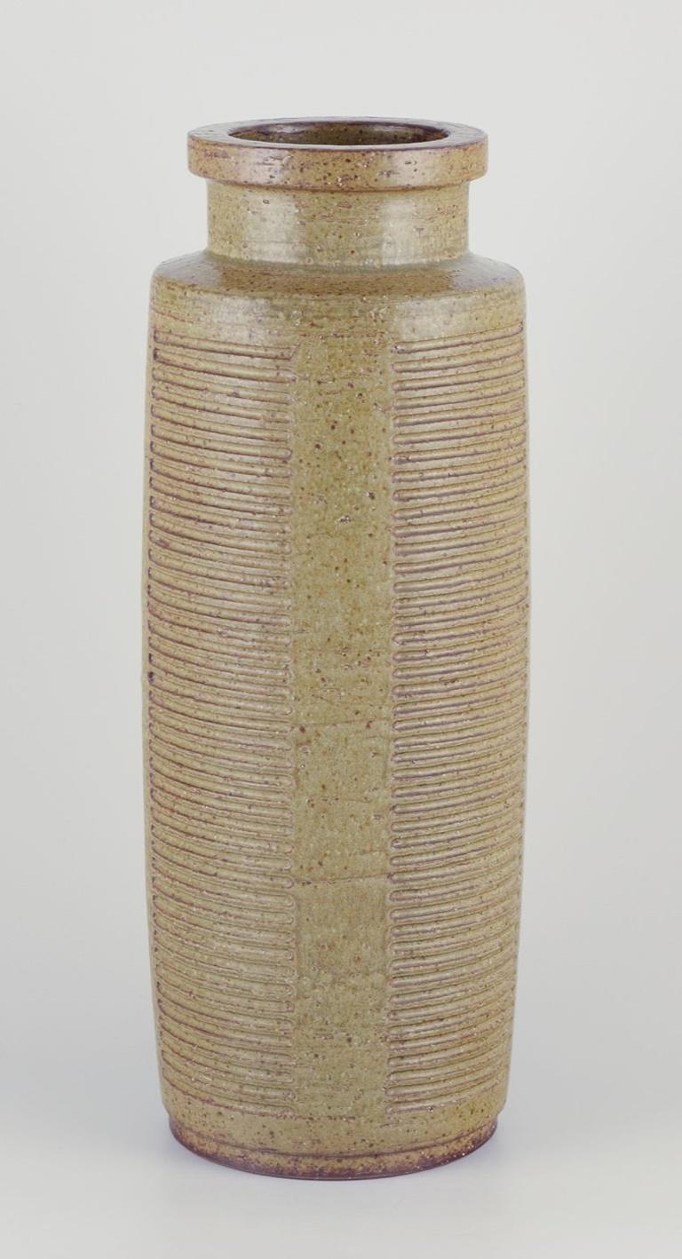 Pre-owned goods are exempt from import duties for U.S. customers. 
Therefore, no import tariffs will be applicable to your purchase.

Per Linnemann-Schmidt for Palshus, Denmark.
Large and impressive floor vase.
Hand-glazed.
Glaze in green and brown