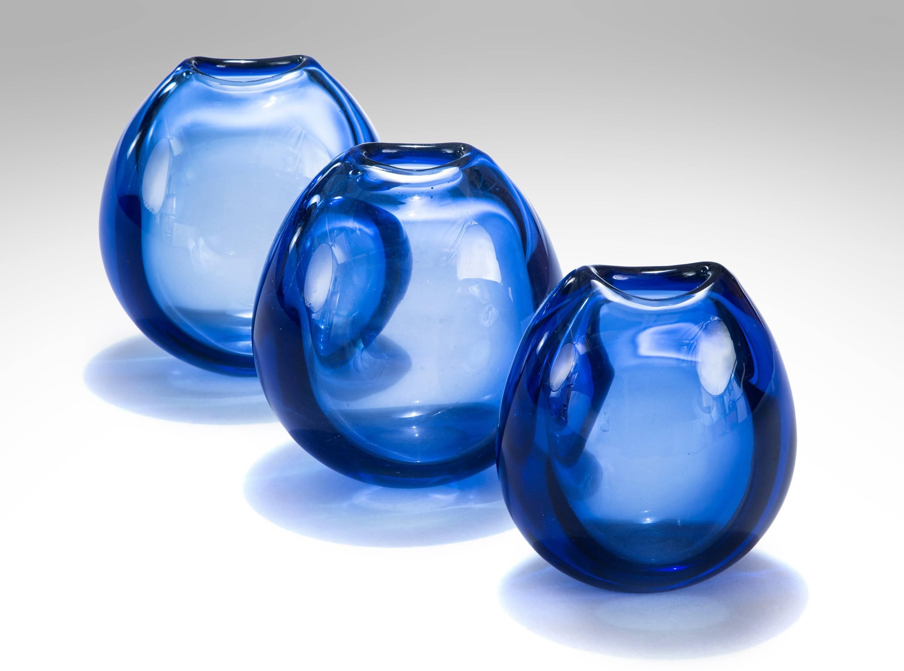 Per Lütken set of three small tear-shaped sapphire blown glass vases
1955
A perfect fusion of form and color creates these ethereal vases. The vases are hand blown resulting in each vase being unique. Of tear drop form, the top with a crescent