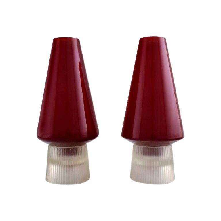 Per Lütken for Holmegaard. A pair of rare "Hygge" lamps for candles in red