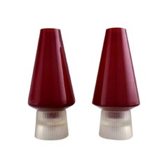 Used Per Lütken for Holmegaard. A pair of rare "Hygge" lamps for candles in red