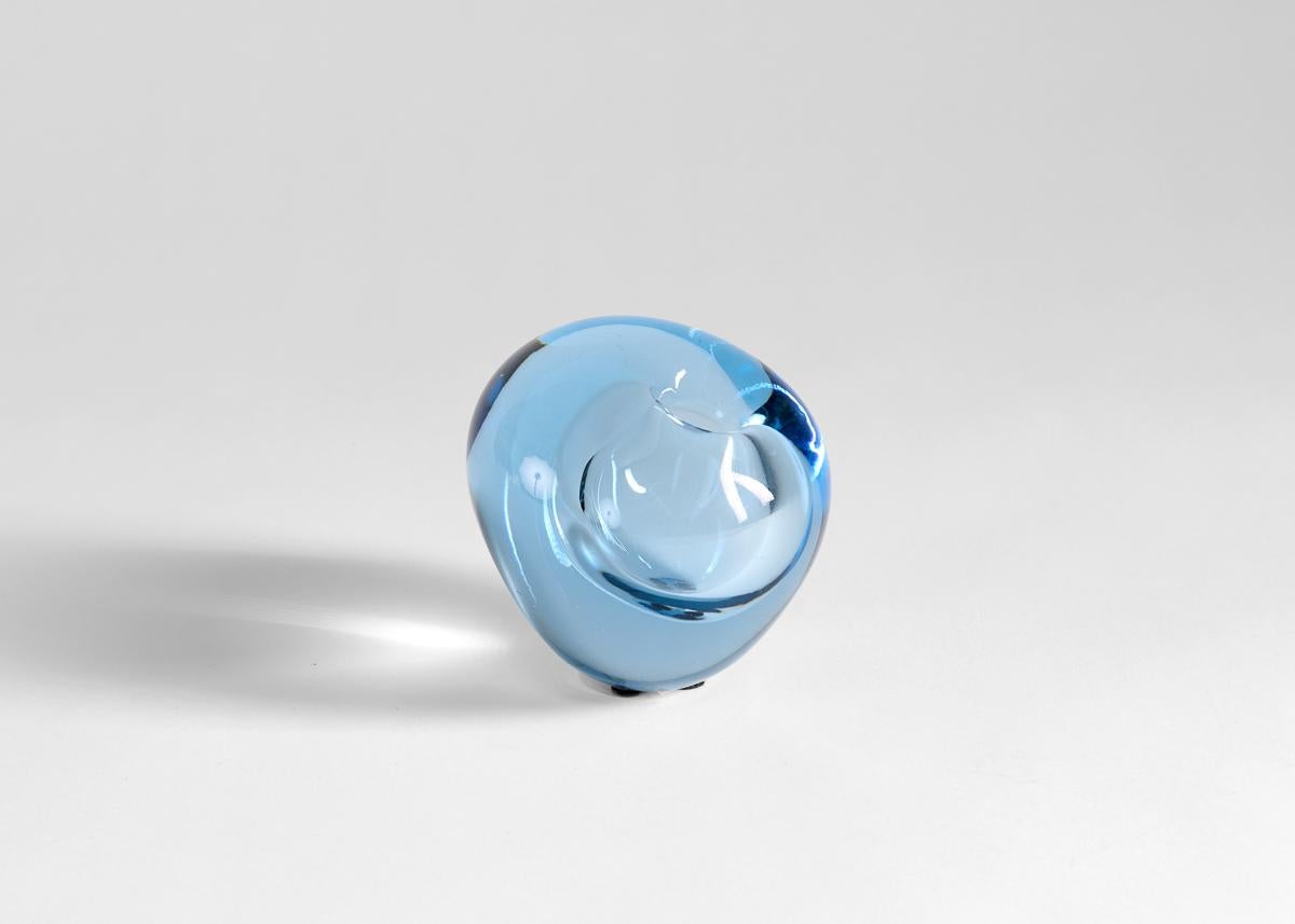 This asymmetrical vase appears as a drop of water with an uncanny depth, beautiful in its icy blue hue.

Signed and numbered 
