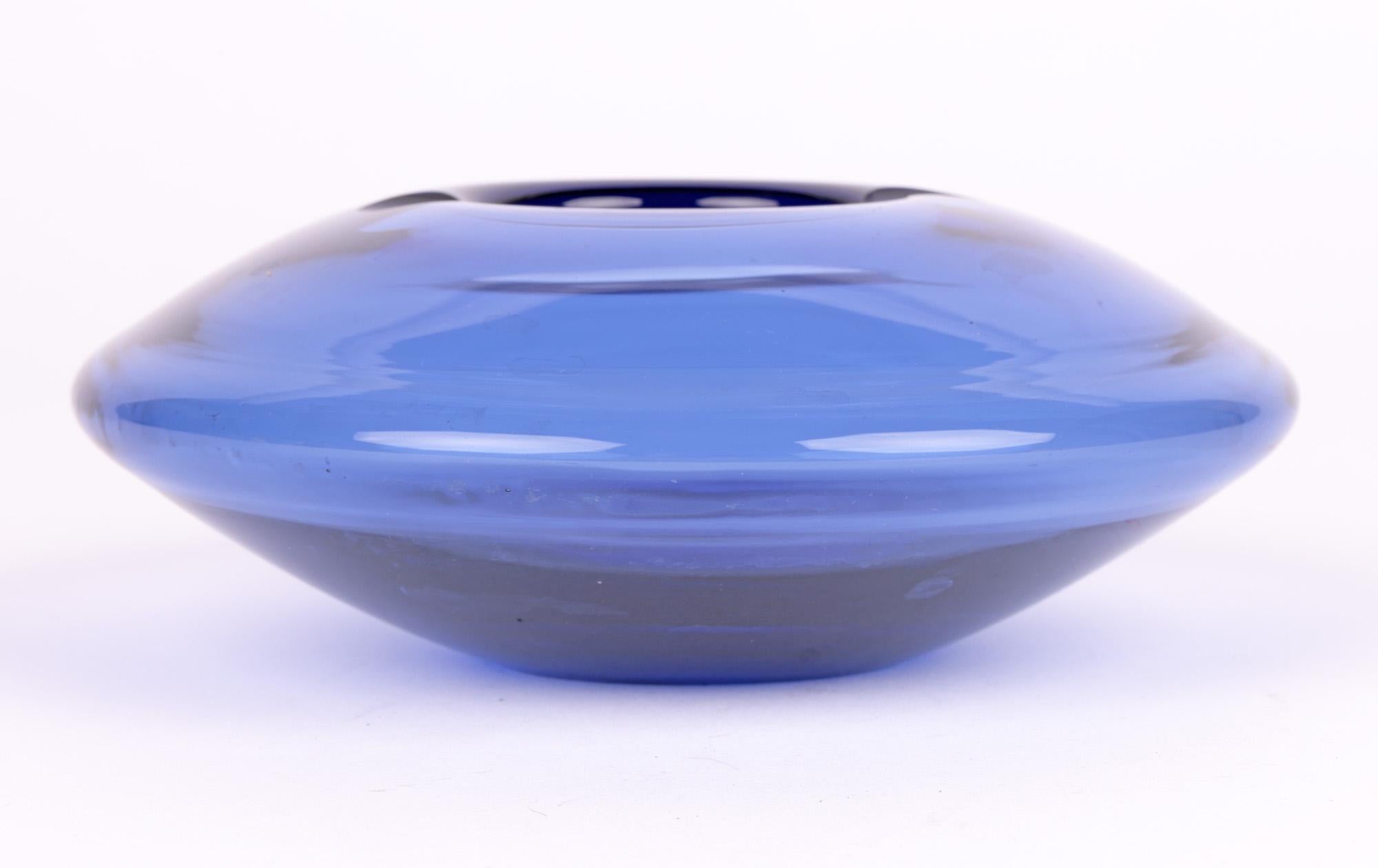 A stylish mid-century Danish blue glass ashtray stylized as a spaceship designed by renowned glass maker Per Lütken (Danish, 1916-1998) for the Holmegaard glass factory and dating from around 1960. 
Per Lütken was a leading designer who worked at