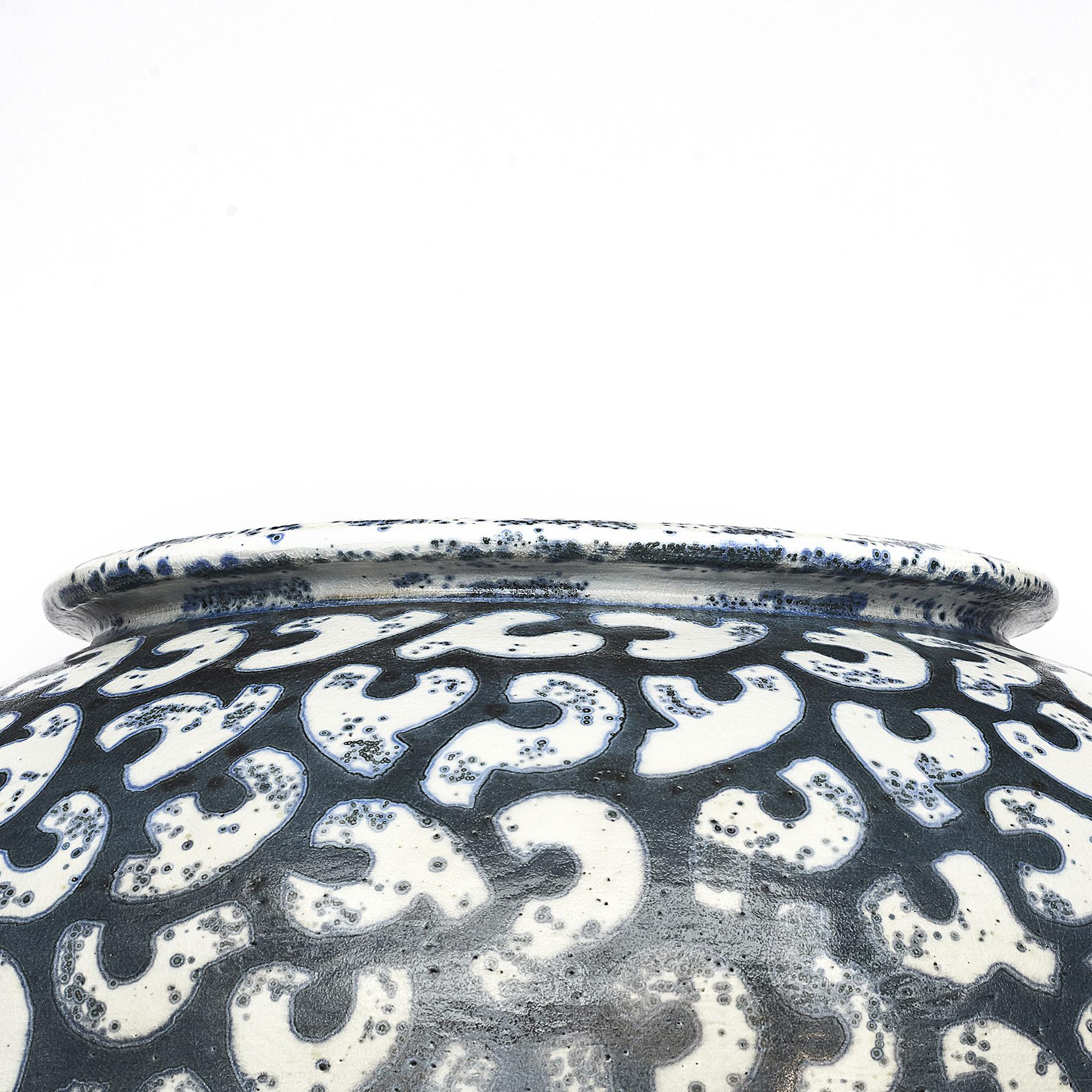 Per Weiss (Danish, born 1953) colossal stoneware floor vase with relief windings. Beautiful stoneware decorated in white, blue and dark glaze.
Artist signature stamp on rim.
Handmade, unique.