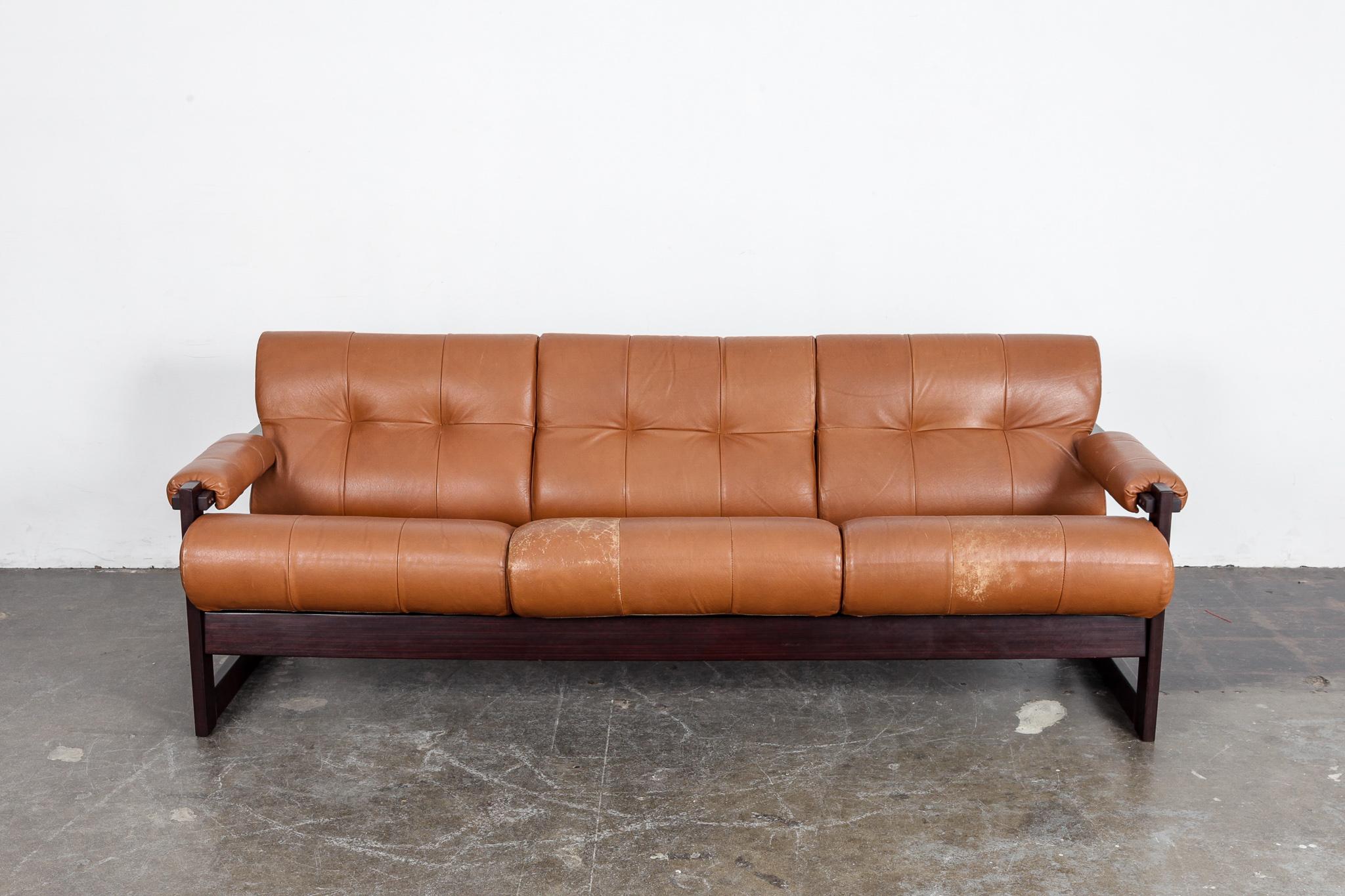 Percival Lafer designed 3-seat tufted sofa in original burnt orange leather with jatoba wood frame, model MP-167, produced by Lafer MP, Brazil, 1960s. Leather shows some patina and wear, consistent with age, especially on 2 of the seat cushions as